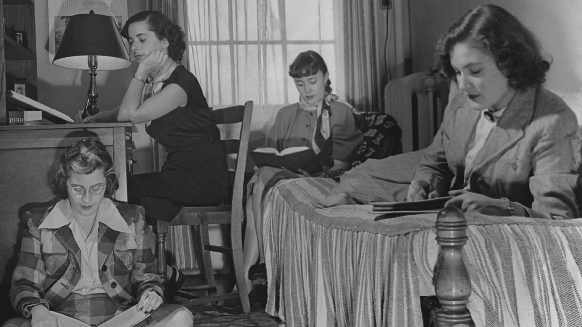 Four female students studying in a dorm room circa 1950's.