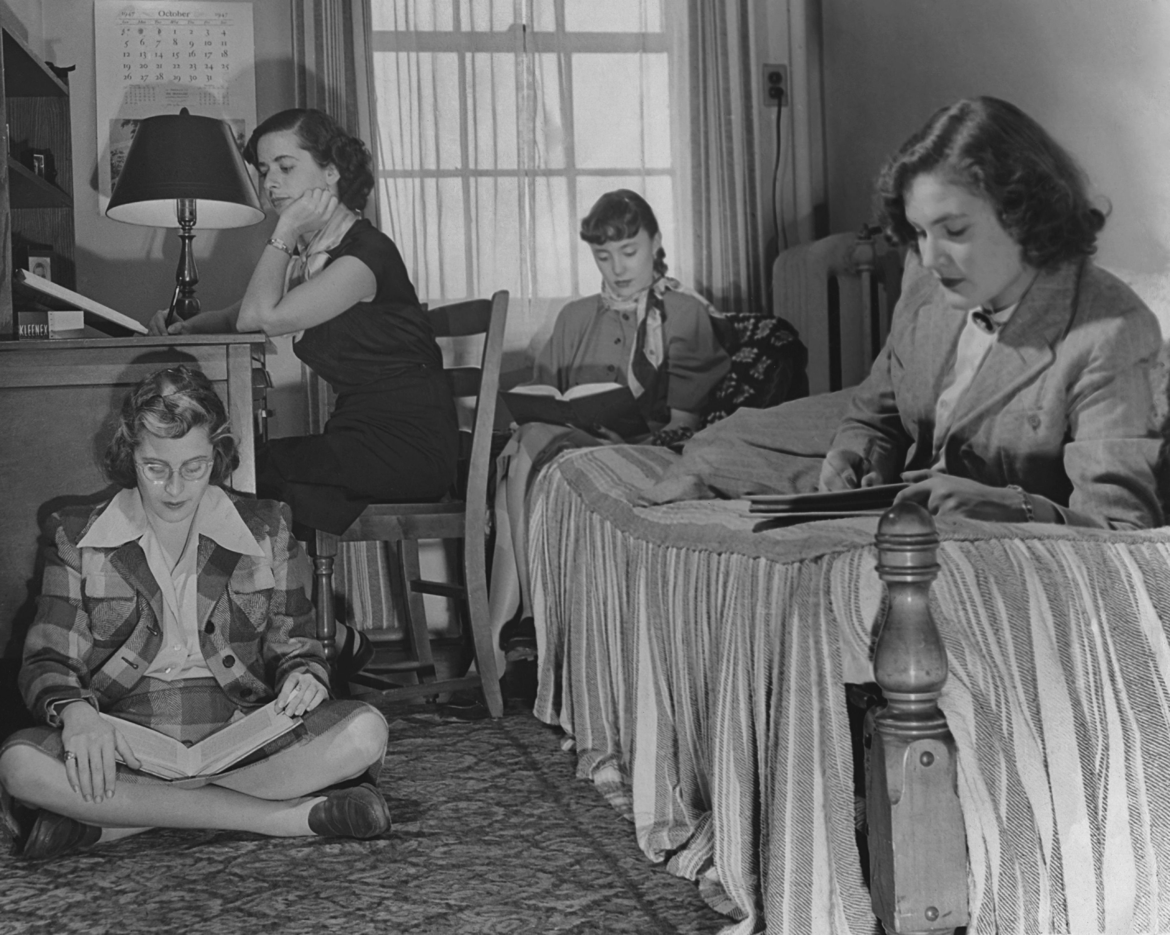 Four female students studying in a dorm room circa 1950's.