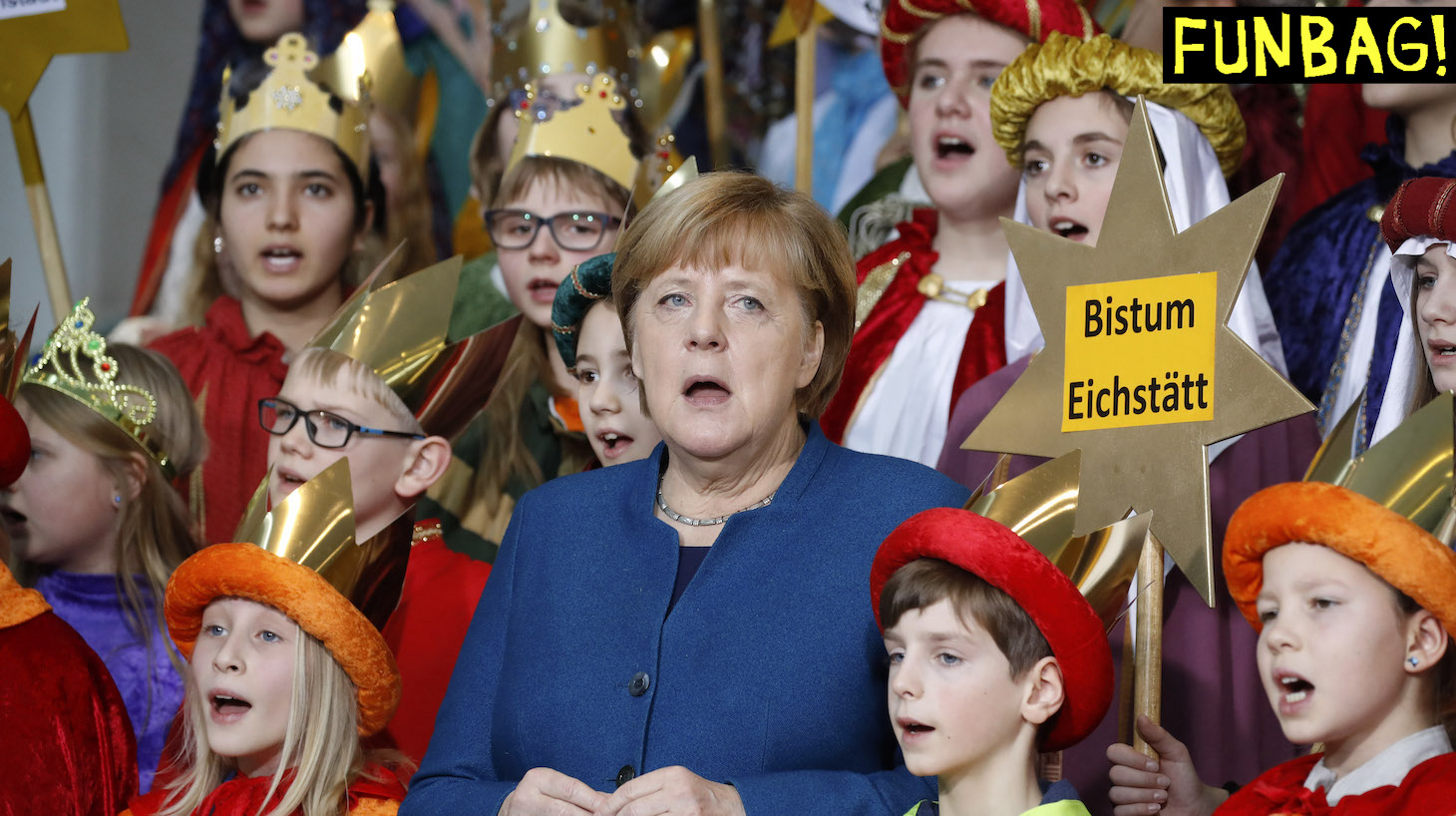 German Chancellor Angela Merkel sings with Carol Singers from across the country during a reception at the Chancellery in Berlin on January 7, 2020. - Traditionally, children dressed as the Three Kings go from house to house after Christmas and before Epiphany to collect money for charitable projects of the Roman Catholic church. (Photo by Odd ANDERSEN / AFP) (Photo by ODD ANDERSEN/AFP via Getty Images)