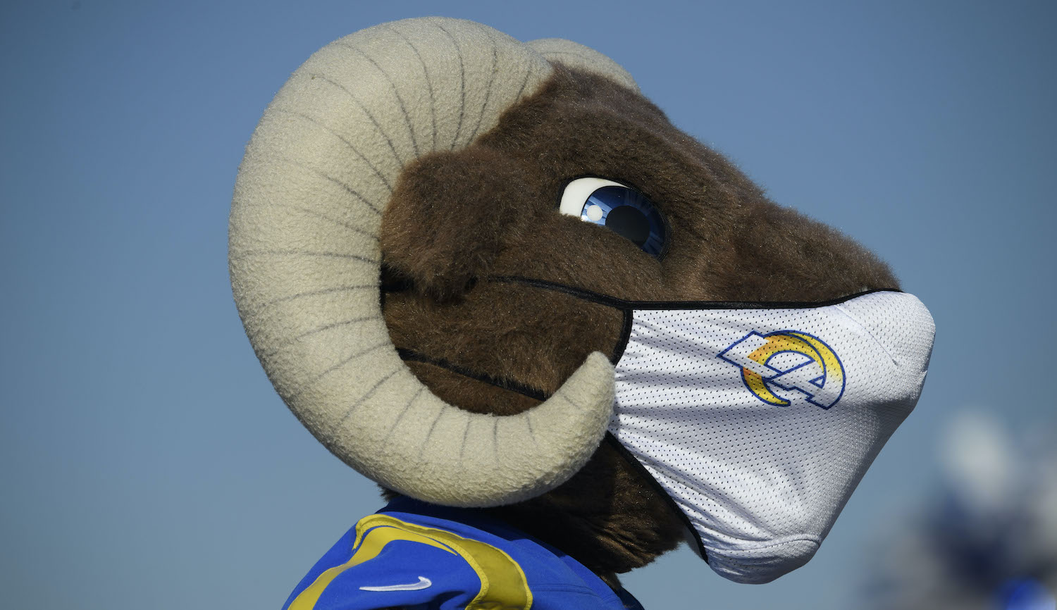 TOPSHOT - The Los Angeles Rams mascot Rampage wears a face mask as drivers wait in line during a holiday mobile food distribution from the Los Angeles Regional Food Bank supported by the Los Angeles Rams NFL football team and Pechanga Resort Casino outside of SoFi Stadium on December 22, 2020 in Inglewood, California. - The Los Angeles Regional Food Bank has distributed 145 million pounds of food since the Covid-19 pandemic started. (Photo by Patrick T. Fallon / AFP) (Photo by PATRICK T. FALLON/AFP via Getty Images)