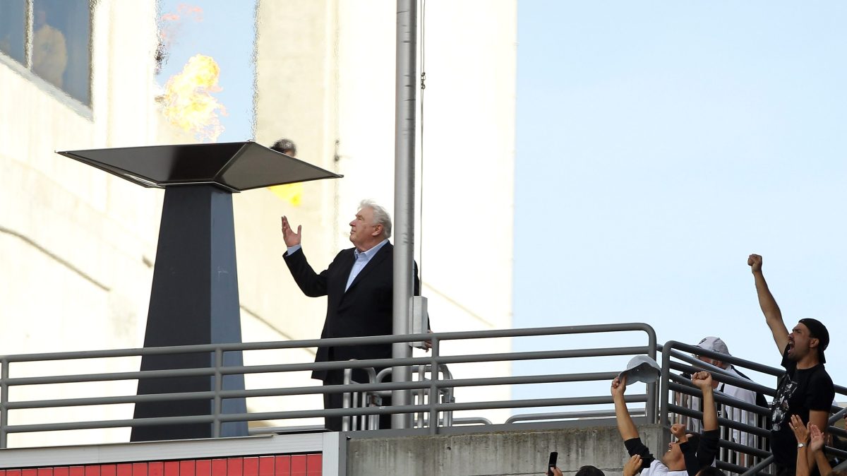 John Madden points to the sky after lighting a flame in the honor of Oakland Raiders owner Al Davis during halftime of their game against the Cleveland Browns at O.co Coliseum on October 16, 2011 in Oakland, California.