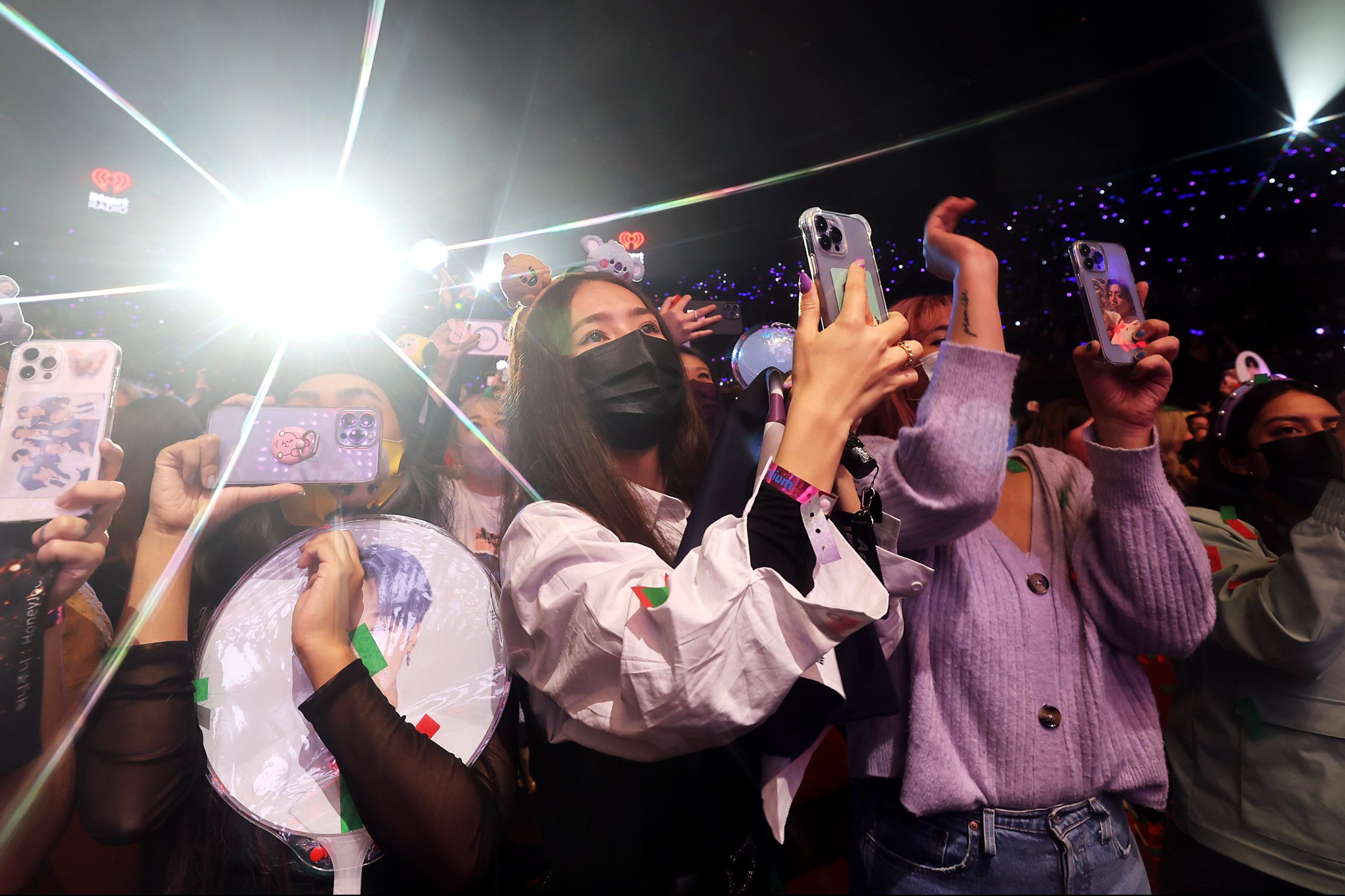 Concert-goers watch BTS perform onstage during iHeartRadio 102.7 KIIS FM's Jingle Ball 2021 presented by Capital One at The Forum on December 03, 2021 in Los Angeles, California.