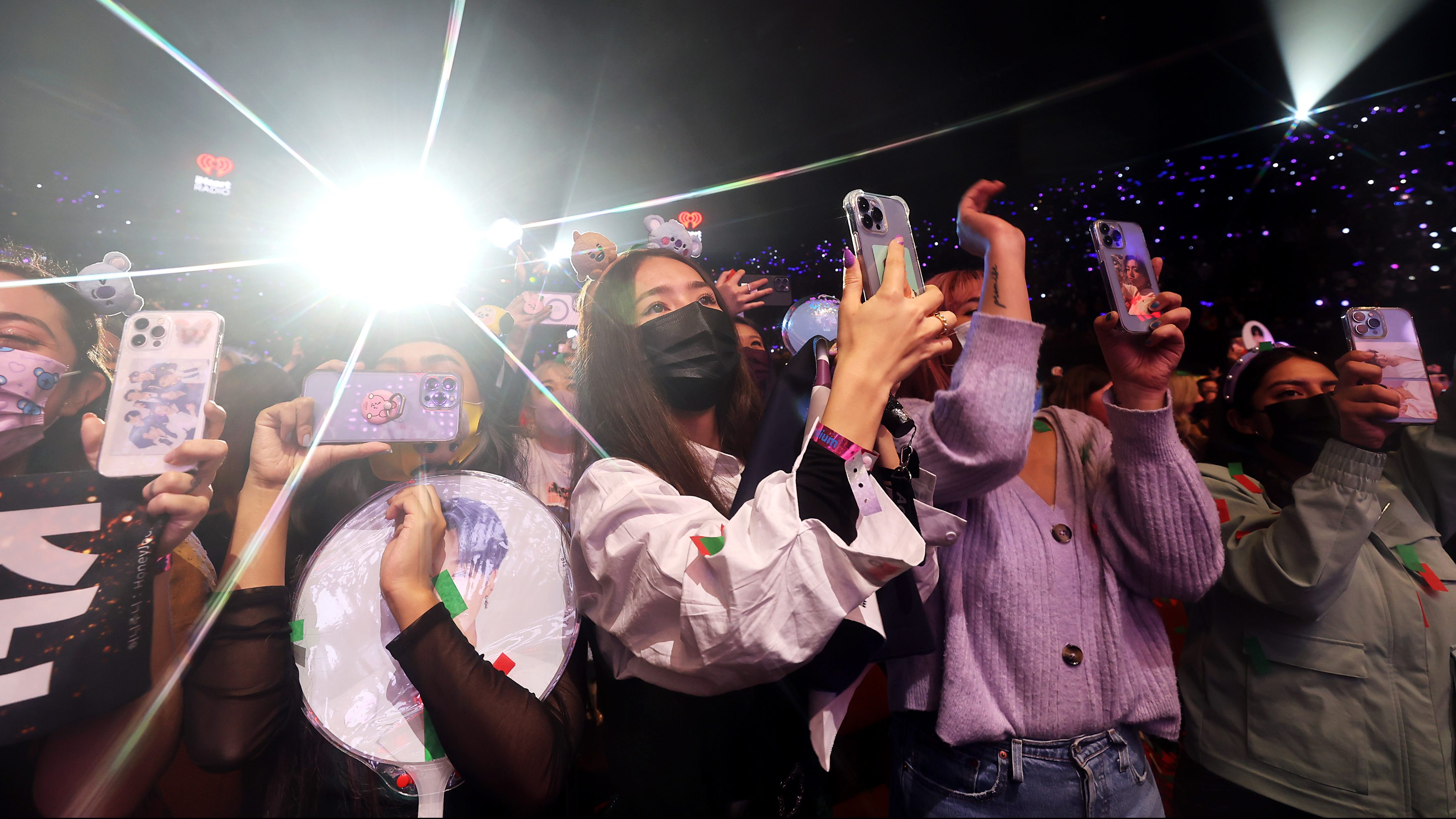 Concert-goers watch BTS perform onstage during iHeartRadio 102.7 KIIS FM's Jingle Ball 2021 presented by Capital One at The Forum on December 03, 2021 in Los Angeles, California.