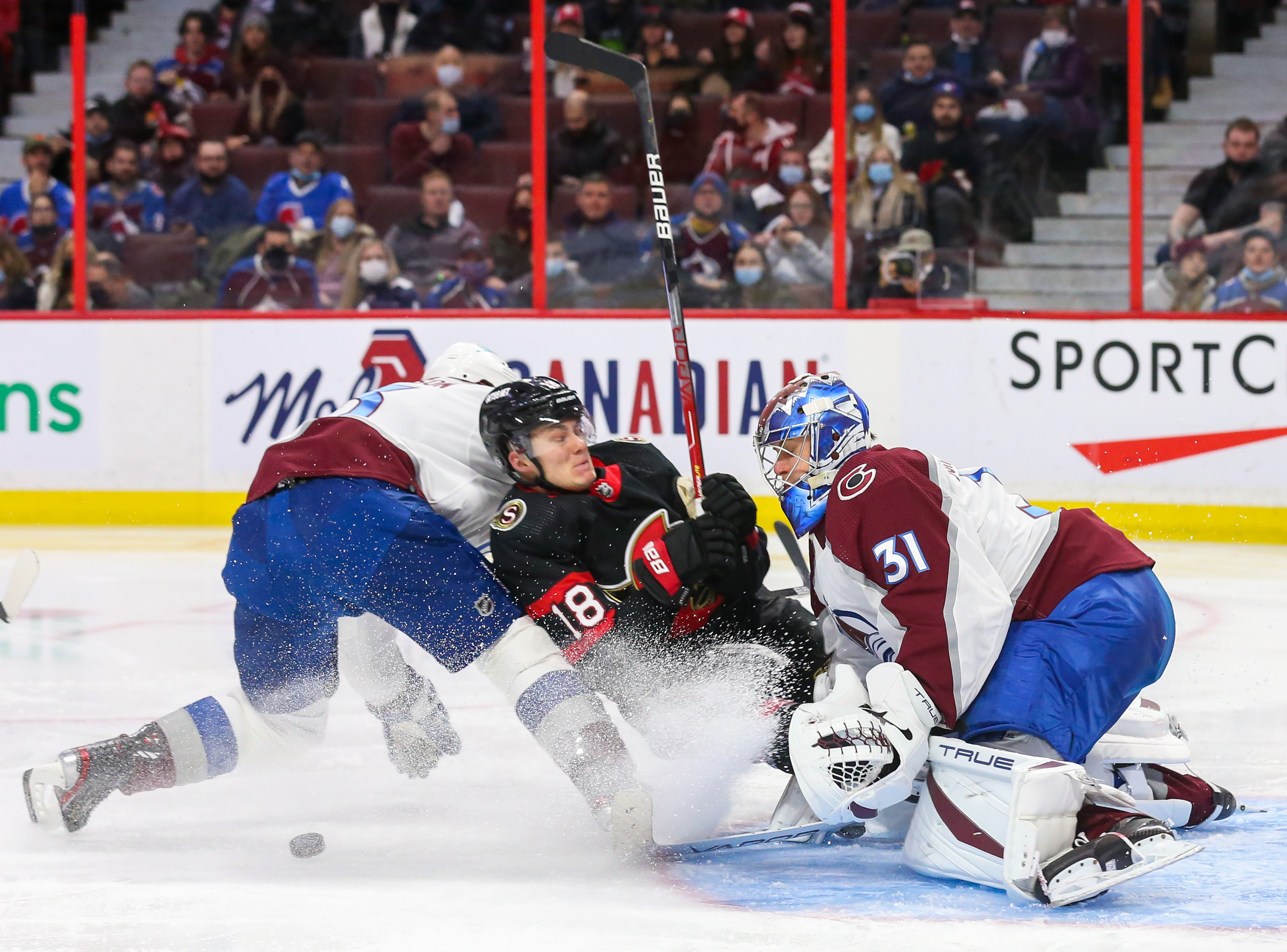 Tim Stützle crashes into the goalie