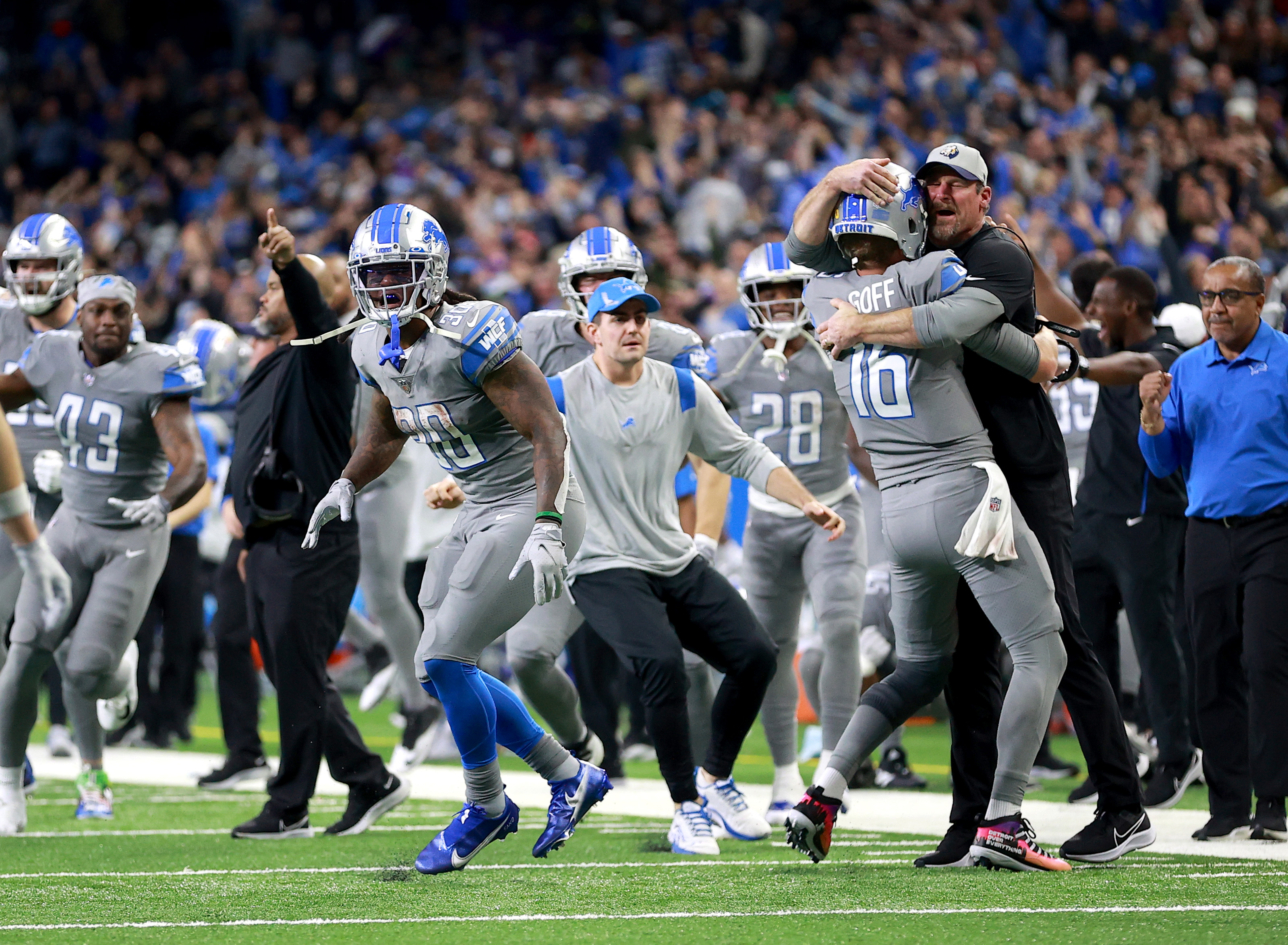 Jared Goff celebrates with Dan Campbell