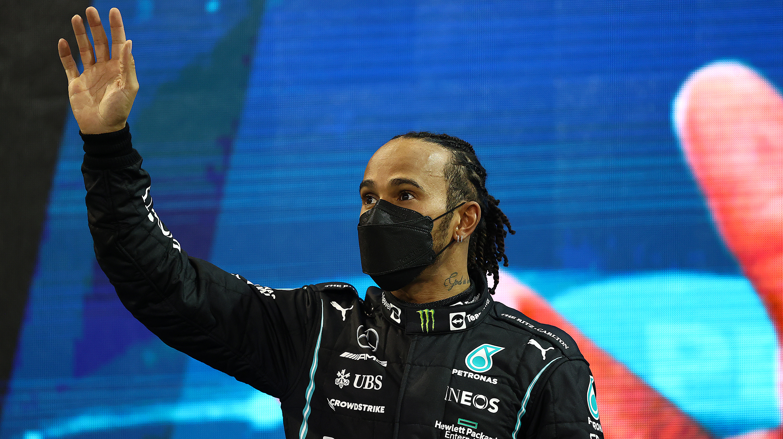 Second placed Lewis Hamilton of Great Britain and Mercedes GP waves from the podium during the F1 Grand Prix of Abu Dhabi at Yas Marina Circuit on December 12, 2021 in Abu Dhabi, United Arab Emirates.