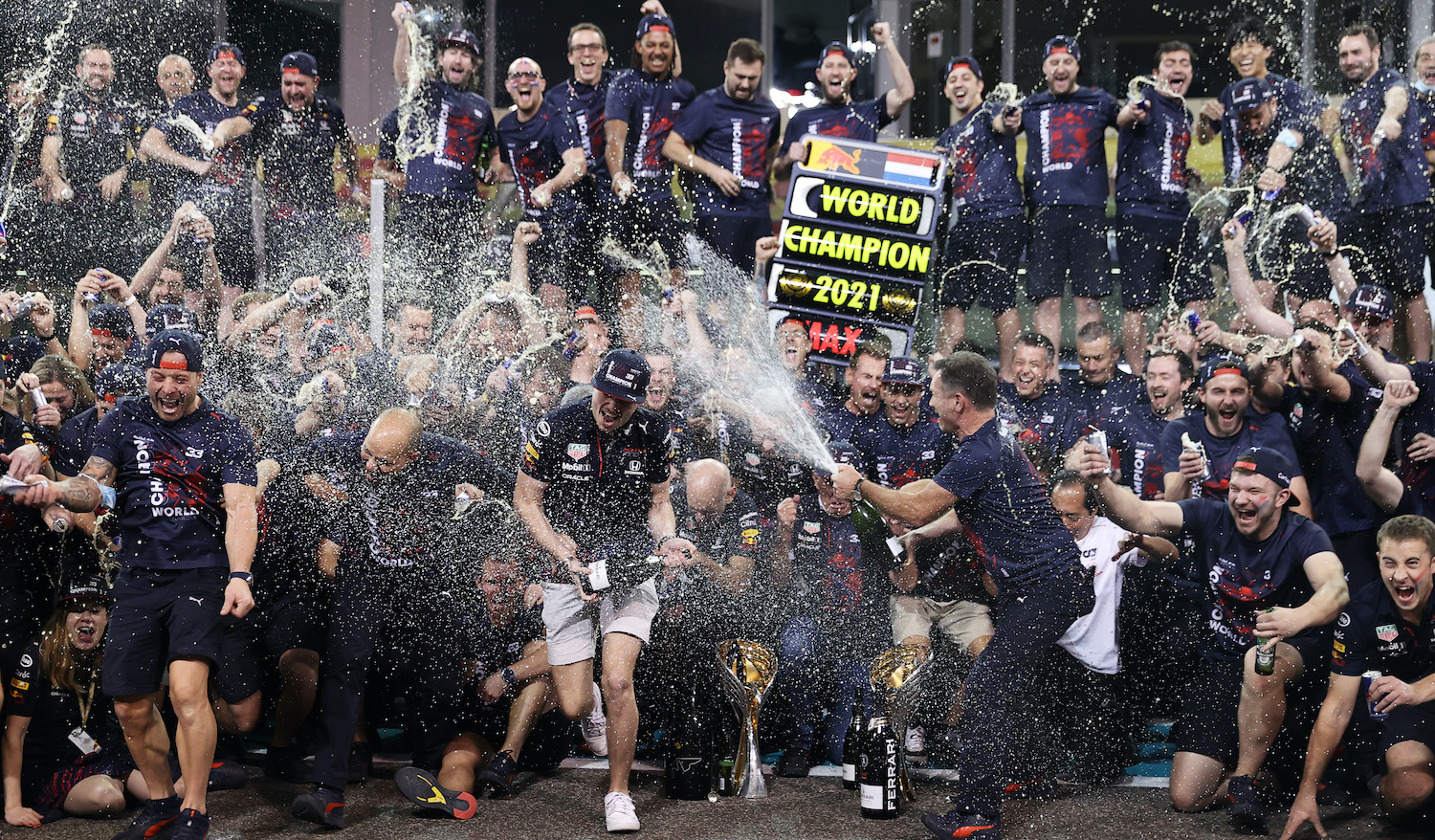 ABU DHABI, UNITED ARAB EMIRATES - DECEMBER 12: Race winner and 2021 F1 World Drivers Champion Max Verstappen of Netherlands and Red Bull Racing celebrates with his team after the F1 Grand Prix of Abu Dhabi at Yas Marina Circuit on December 12, 2021 in Abu Dhabi, United Arab Emirates. (Photo by Lars Baron/Getty Images)
