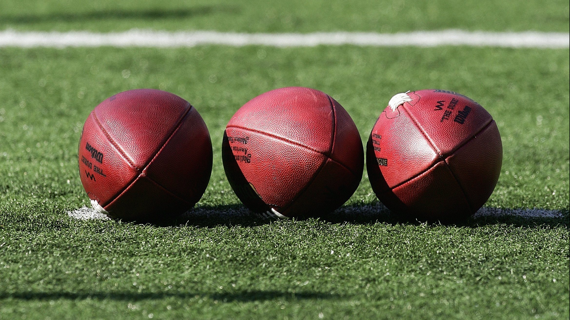 Three footballs lay on the field prior to the game between the Cincinnati Bengals and the Baltimore Ravens at M&T Bank Stadium on November 5, 2006 in Baltimore, Maryland.