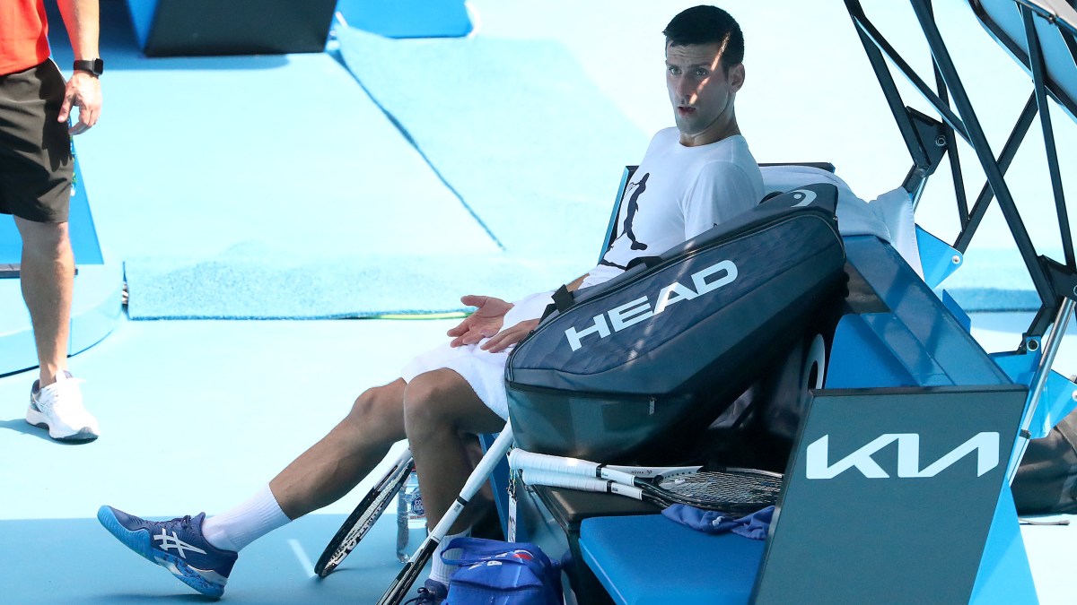 Novak Djokovic sits down while practicing on the grounds of the Australian Open.