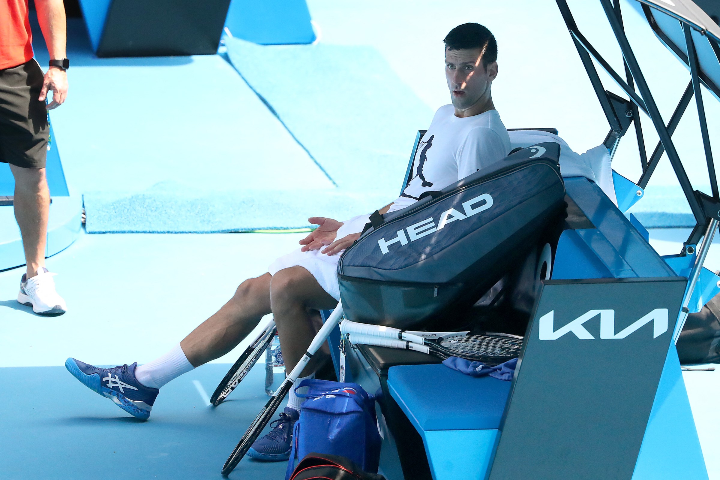 Novak Djokovic sits down while practicing on the grounds of the Australian Open.