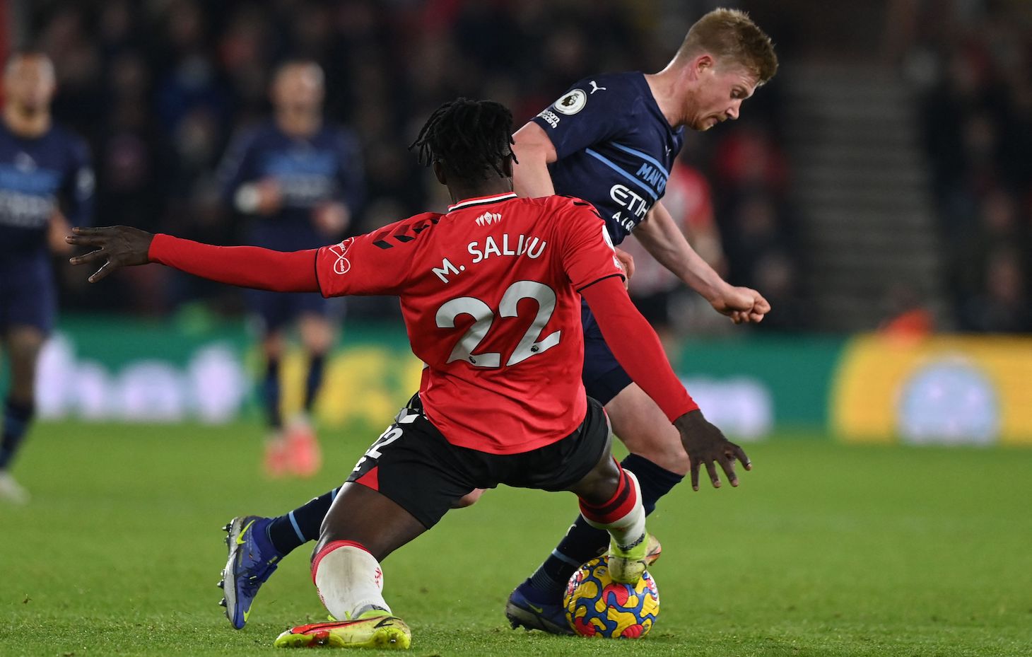 Manchester City's Belgian midfielder Kevin De Bruyne is tackled by Southampton's Ghanaian defender Mohammed Salisu during the English Premier League football match between Southampton and Manchester City at St Mary's Stadium in Southampton, southern England on January 22, 2022.