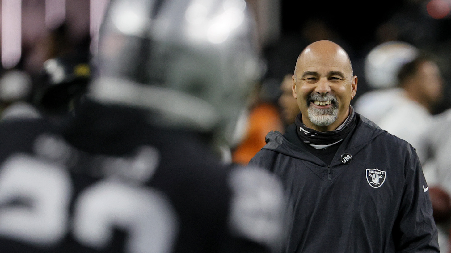 LAS VEGAS, NEVADA - JANUARY 09: Interim head coach/special teams coordinator Rich Bisaccia of the Las Vegas Raiders smiles as the team warms up before their game against the Los Angeles Chargers at Allegiant Stadium on January 9, 2022 in Las Vegas, Nevada. The Raiders defeated the Chargers 35-32 in overtime. (Photo by Ethan Miller/Getty Images)