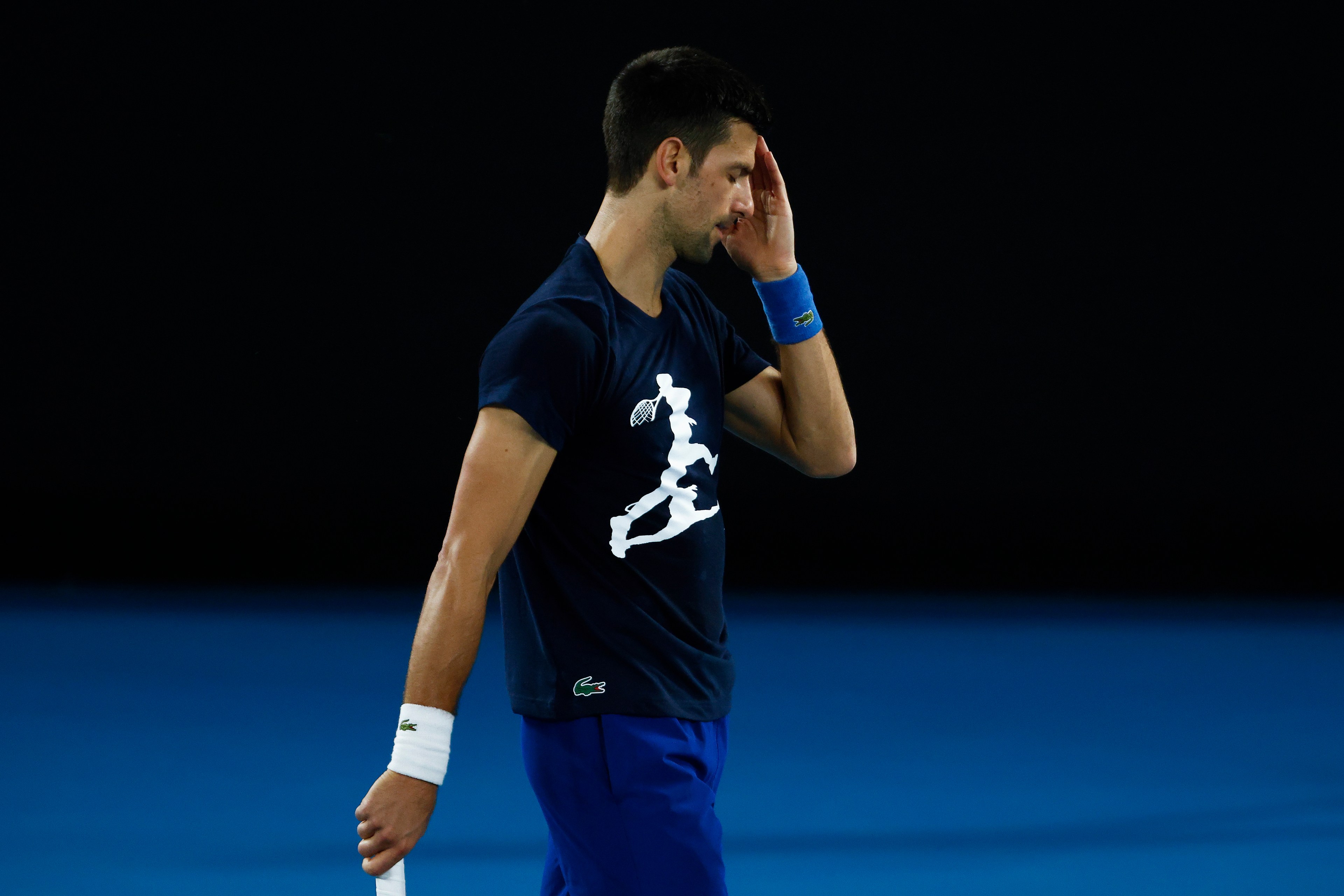 MELBOURNE, AUSTRALIA - JANUARY 14: Novak Djokovic of Serbia reacts during a practice session ahead of the 2022 Australian Open at Melbourne Park on January 14, 2022 in Melbourne, Australia.