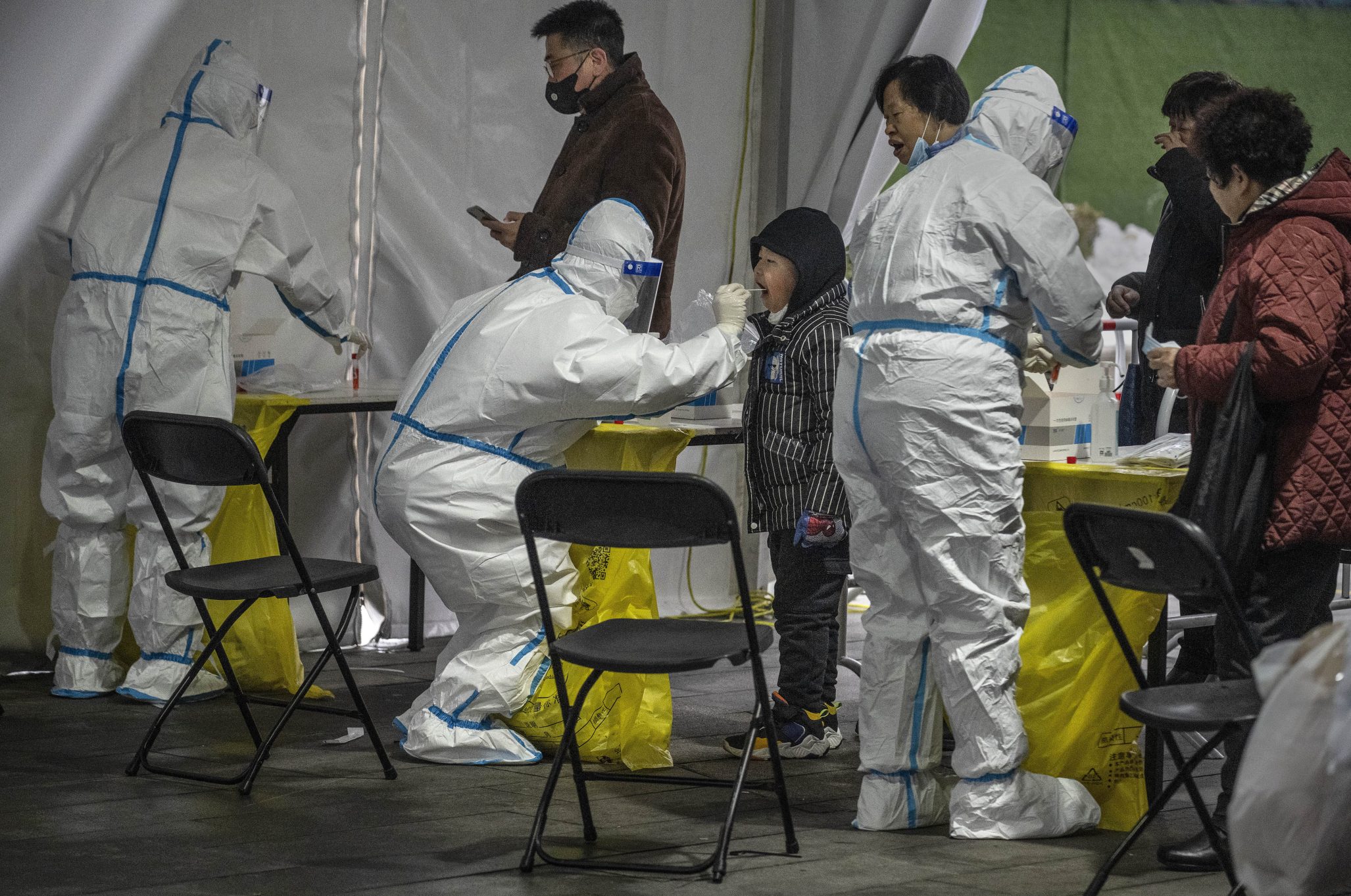 A health care worker gives a COVID test