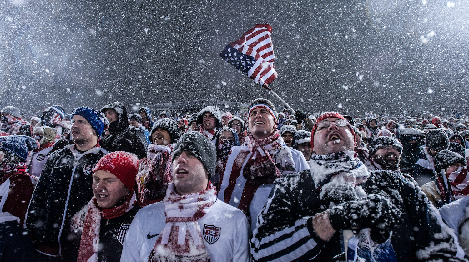 COMMERCE CITY, CO - MARCH 22: Fans of the United States national team cheer, wave a flag, and sing as snow falls during a FIFA 2014 World Cup Qualifier match between Costa Rica and United States at Dick's Sporting Goods Park on March 22, 2013 in Commerce City, Colorado. (Photo by Dustin Bradford/Getty Images)