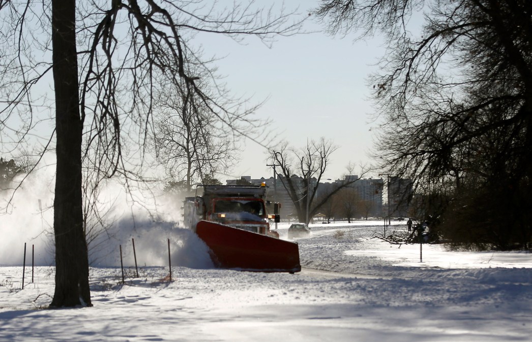 DETROIT, MI - FEBRUARY 2: A snow plow clears snow from a road on Belle Isle February 2, 2015 in Detroit, Michigan. Detroit received over a foot of snow during a storm that has crippled much of the Midwest canceling thousands of flights around the country.