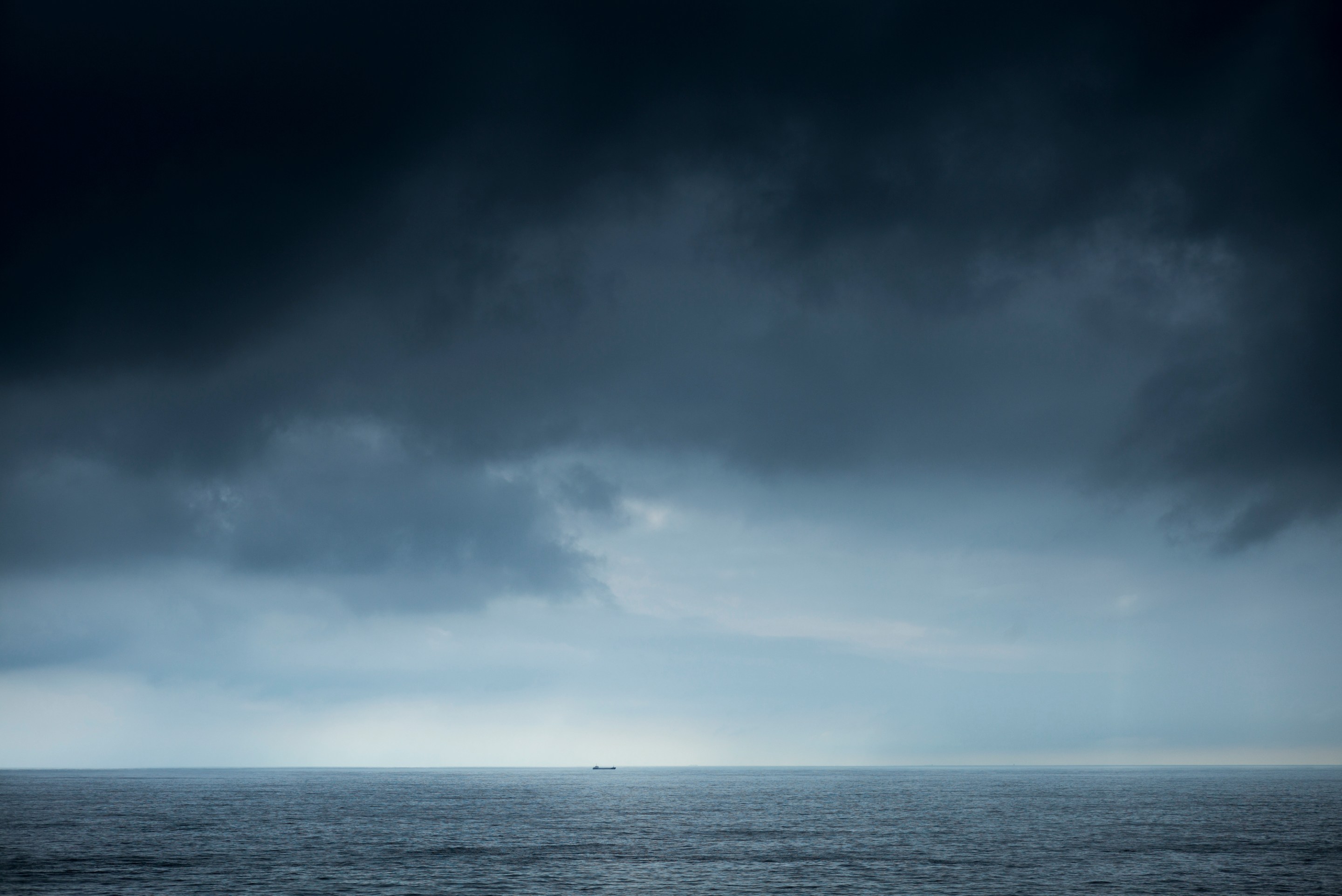 BAY OF BISCAY, SPAIN: Tanker under dark clouds in The Bay of Biscay north of Santander in the Atlantic Ocean, Spain