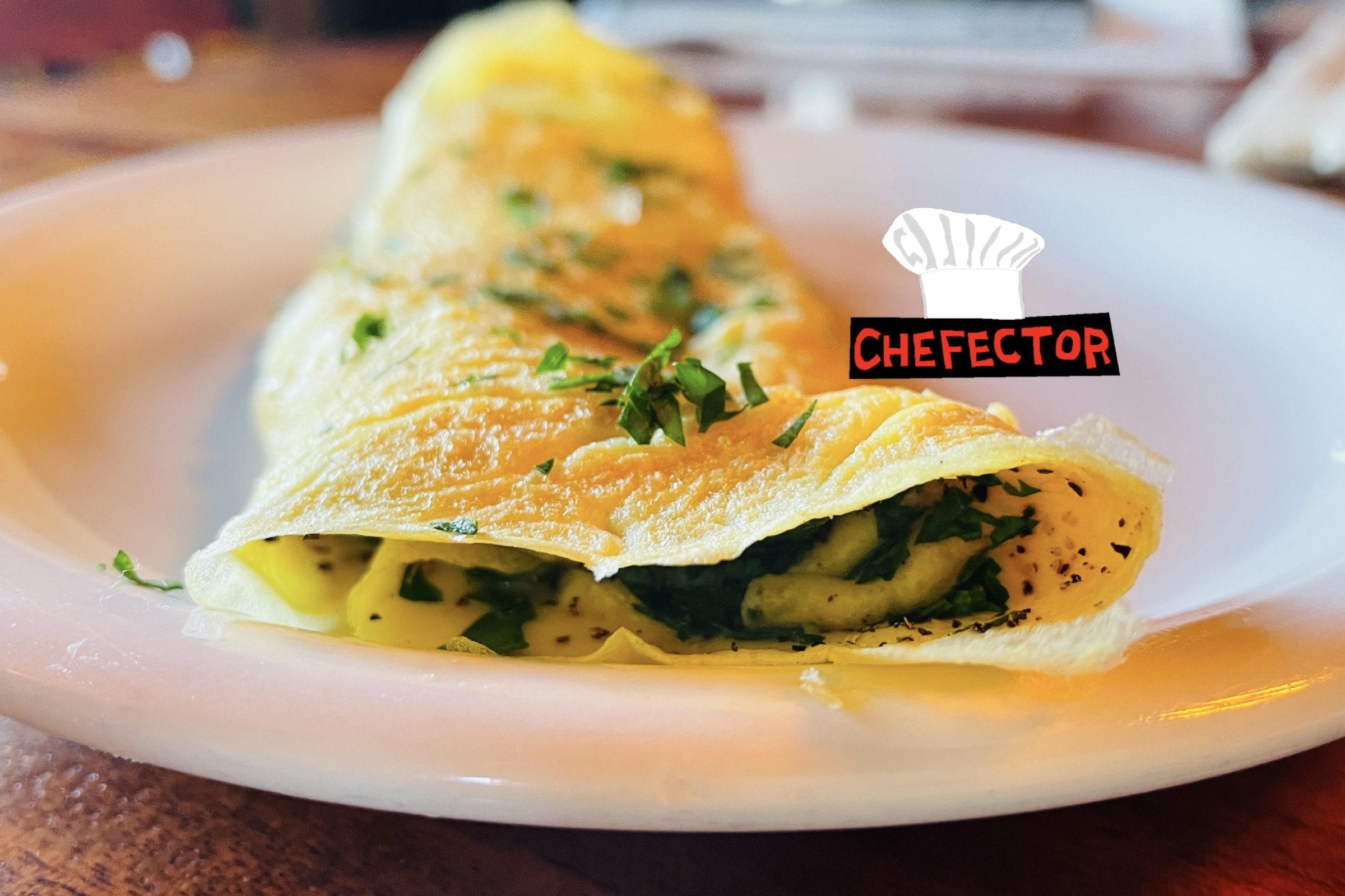 An omelet with herbs on it