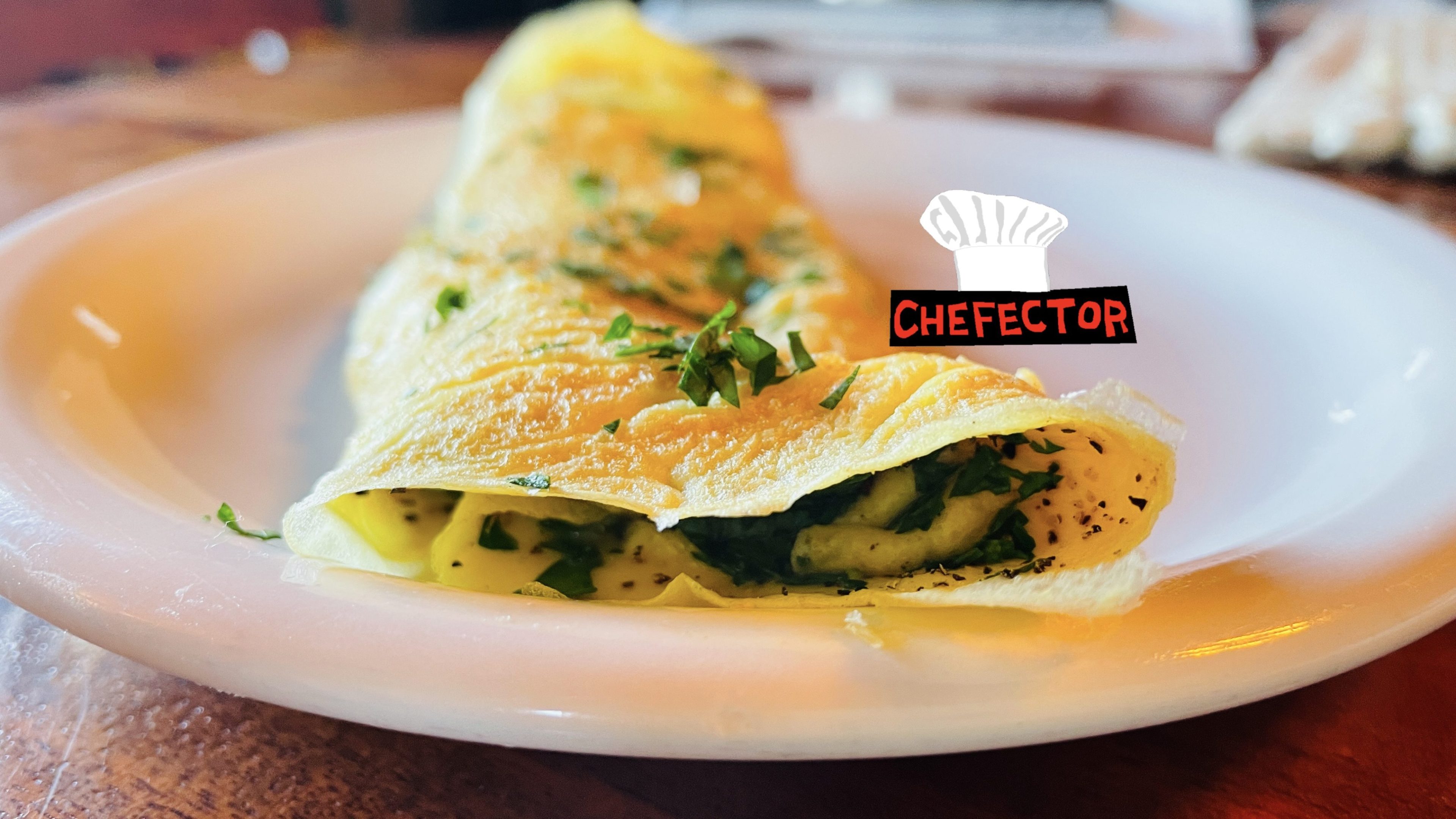 An omelet with herbs on it