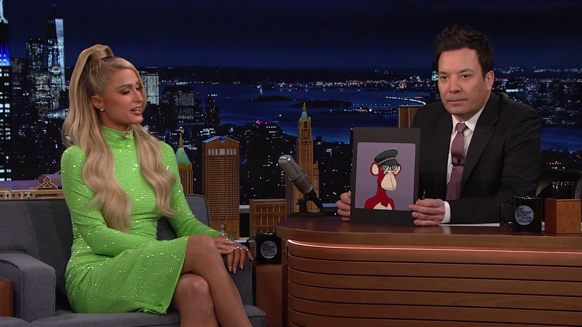 Jimmy Fallon holds NFT on Tonight Show with Paris Hilton.