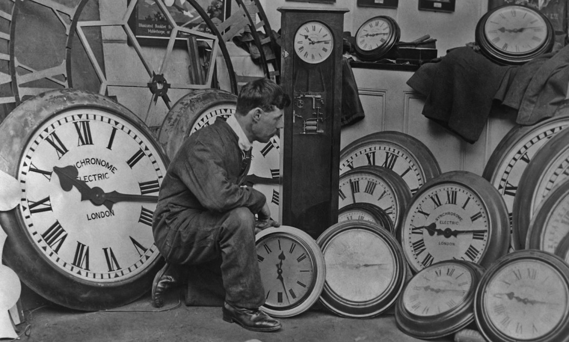 A workman removing the clocks at the close of the British Empire Exhibition held at Wembley in London, England in 1924. (Photo by Henry Miller News Picture Service/FPG/Getty Images)
