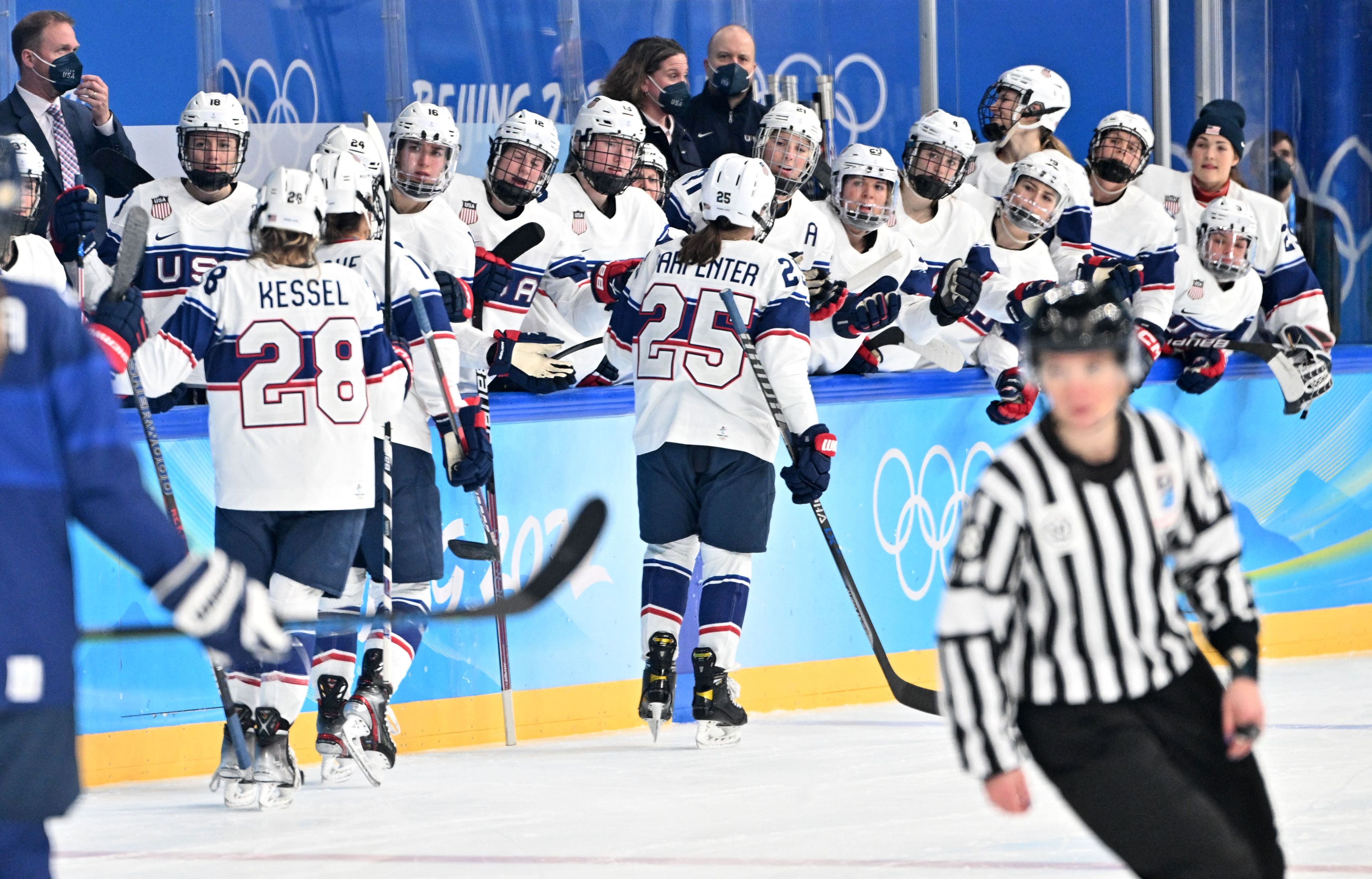 USA's Alexandra Carpenter (C) celebrates with teammates on the bench after scoring a goal against Finland during their women's preliminary round group A match of the Beijing 2022 Winter Olympic Games ice hockey competition, at the Wukesong Sports Centre in Beijing on February 3, 2022.
