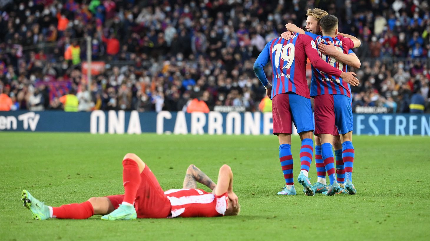 Barcelona's players celebrate their victory at the end of the Spanish league football match between FC Barcelona and Club Atletico de Madrid at the Camp Nou stadium in Barcelona on February 6, 2022.