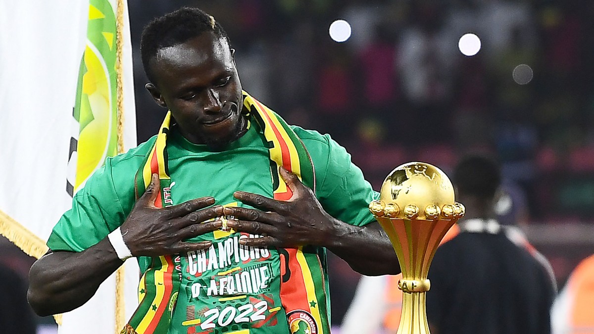 Senegal's forward Sadio Mane looks at the trophy prior to the ceremony after winning after the Africa Cup of Nations (CAN) 2021 final football match between Senegal and Egypt at Stade d'Olembe in Yaounde on February 6, 2022.