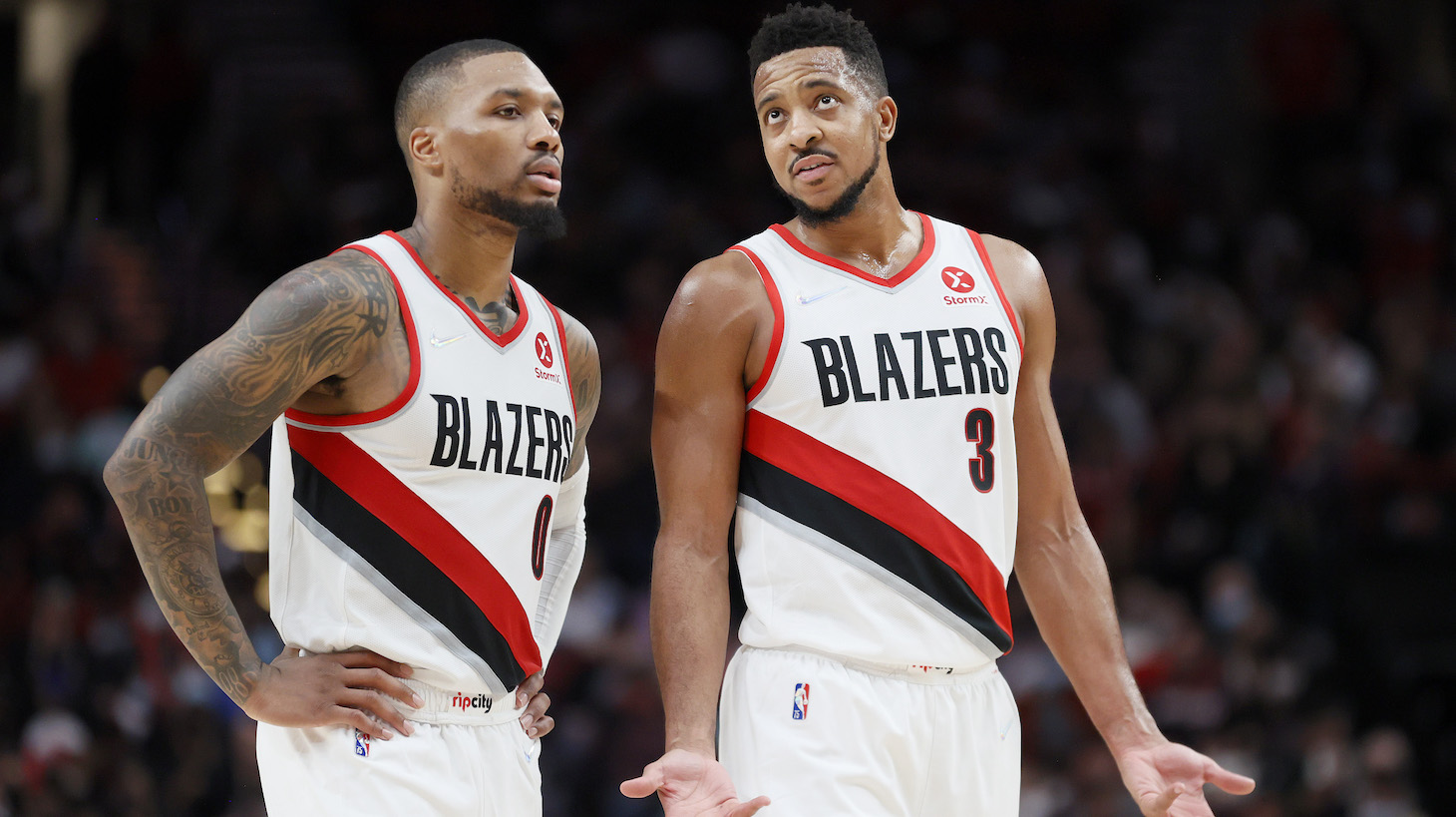PORTLAND, OREGON - OCTOBER 20: Damian Lillard #0 and CJ McCollum #3 of the Portland Trail Blazers react during the fourth quarter against the Sacramento Kings at Moda Center on October 20, 2021 in Portland, Oregon. NOTE TO USER: User expressly acknowledges and agrees that, by downloading and or using this photograph, User is consenting to the terms and conditions of the Getty Images License Agreement. (Photo by Steph Chambers/Getty Images)