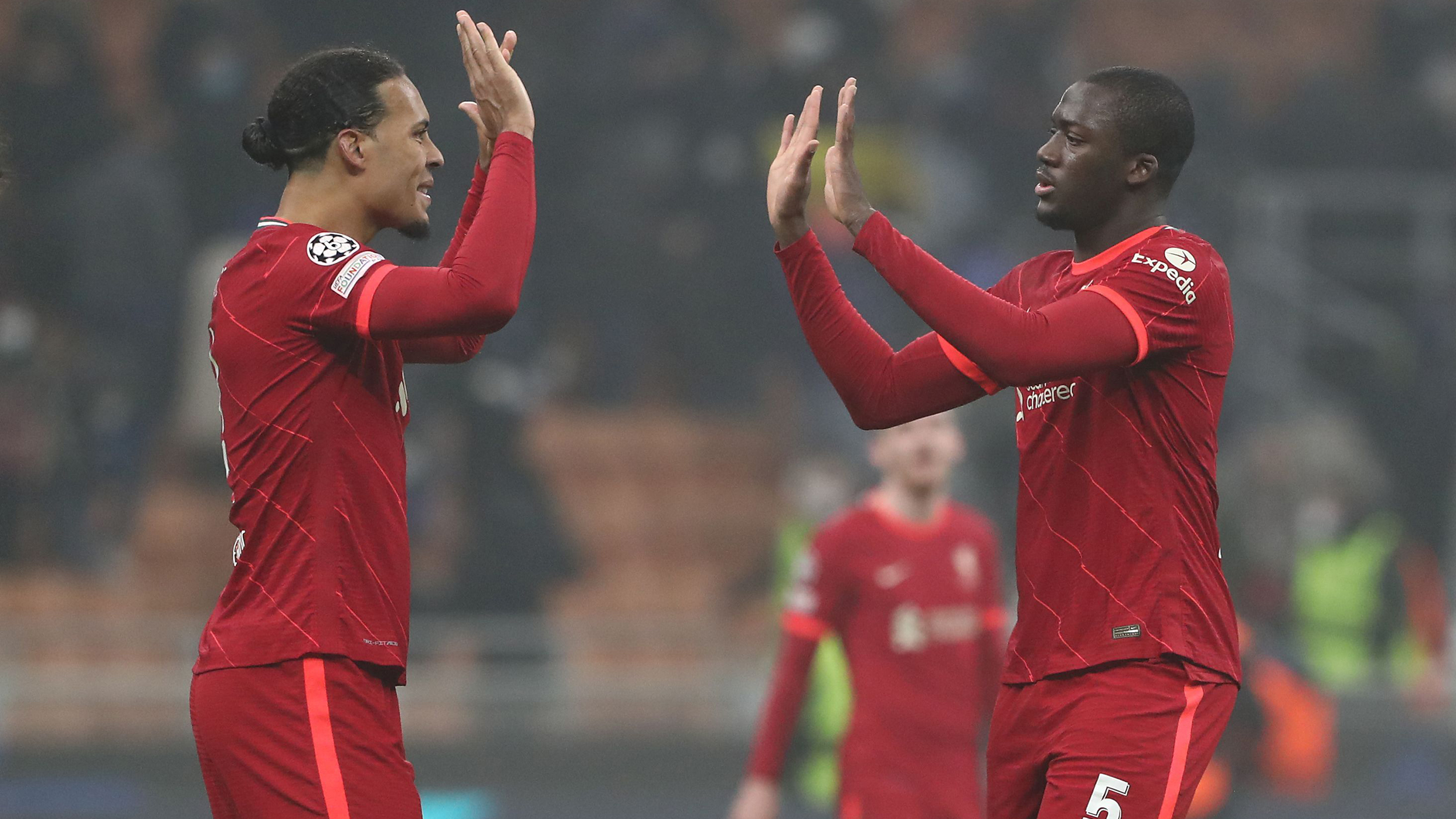 Virgil van Dijk and Ibrahima Konate of Liverpool FC celebrate a victory at the end of the of UEFA Champions League Round Of Sixteen Leg One match between FC Internazionale and Liverpool FC at Giuseppe Meazza Stadium on February 16, 2022 in Milan, Italy.