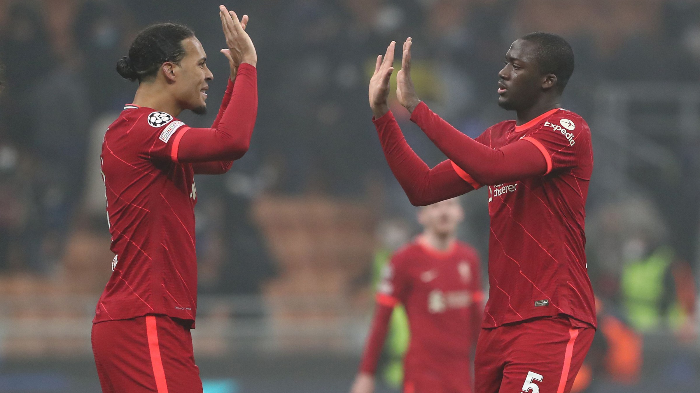 Virgil van Dijk and Ibrahima Konate of Liverpool FC celebrate a victory at the end of the of UEFA Champions League Round Of Sixteen Leg One match between FC Internazionale and Liverpool FC at Giuseppe Meazza Stadium on February 16, 2022 in Milan, Italy.