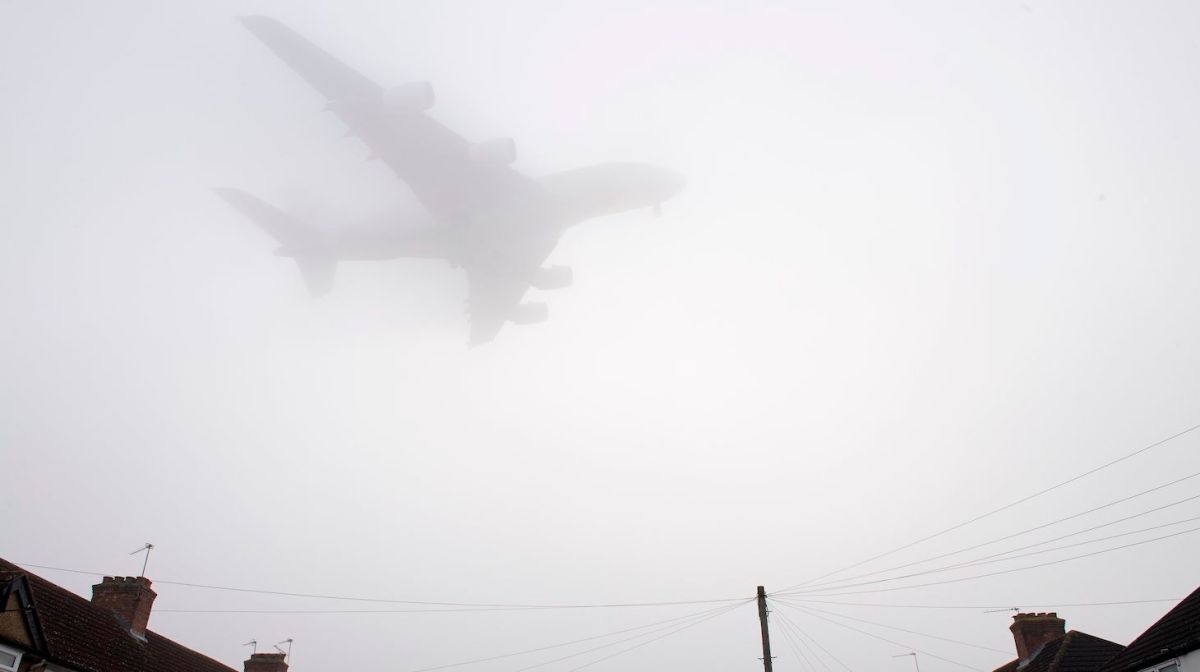 A Etihad Airways Airbus A380 comes in through the fog to land at Heathrow Airport in west London on December 30, 2016. - The Met Office issued a yellow warning of fog, advising that "Driving conditions will be difficult with journeys likely to take longer than usual and delays to air travel possible". (Photo by Justin TALLIS / AFP) (Photo credit should read JUSTIN TALLIS/AFP via Getty Images)