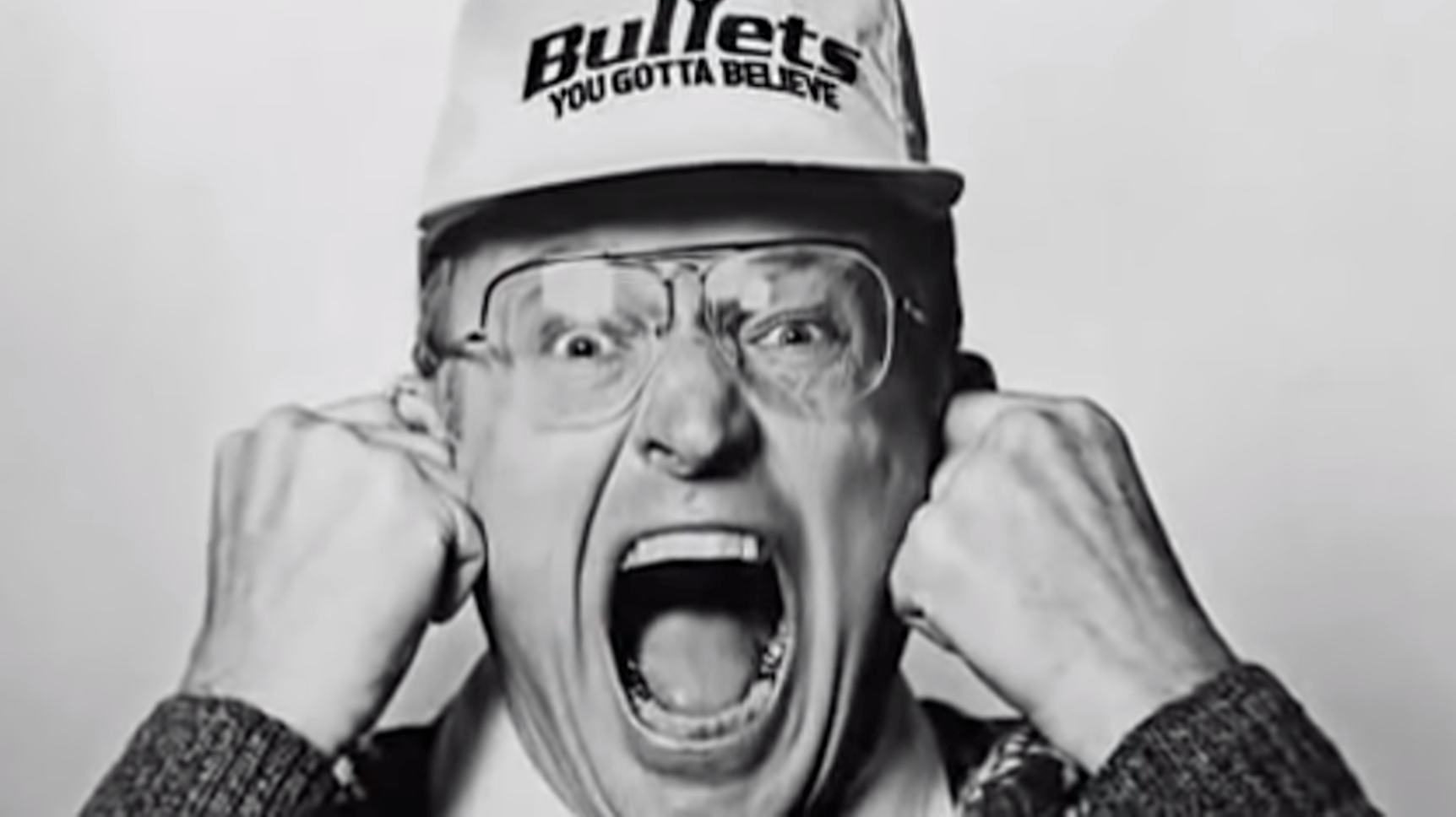 Robin Ficker, seen here wearing a Washington Bullets hat and screaming.