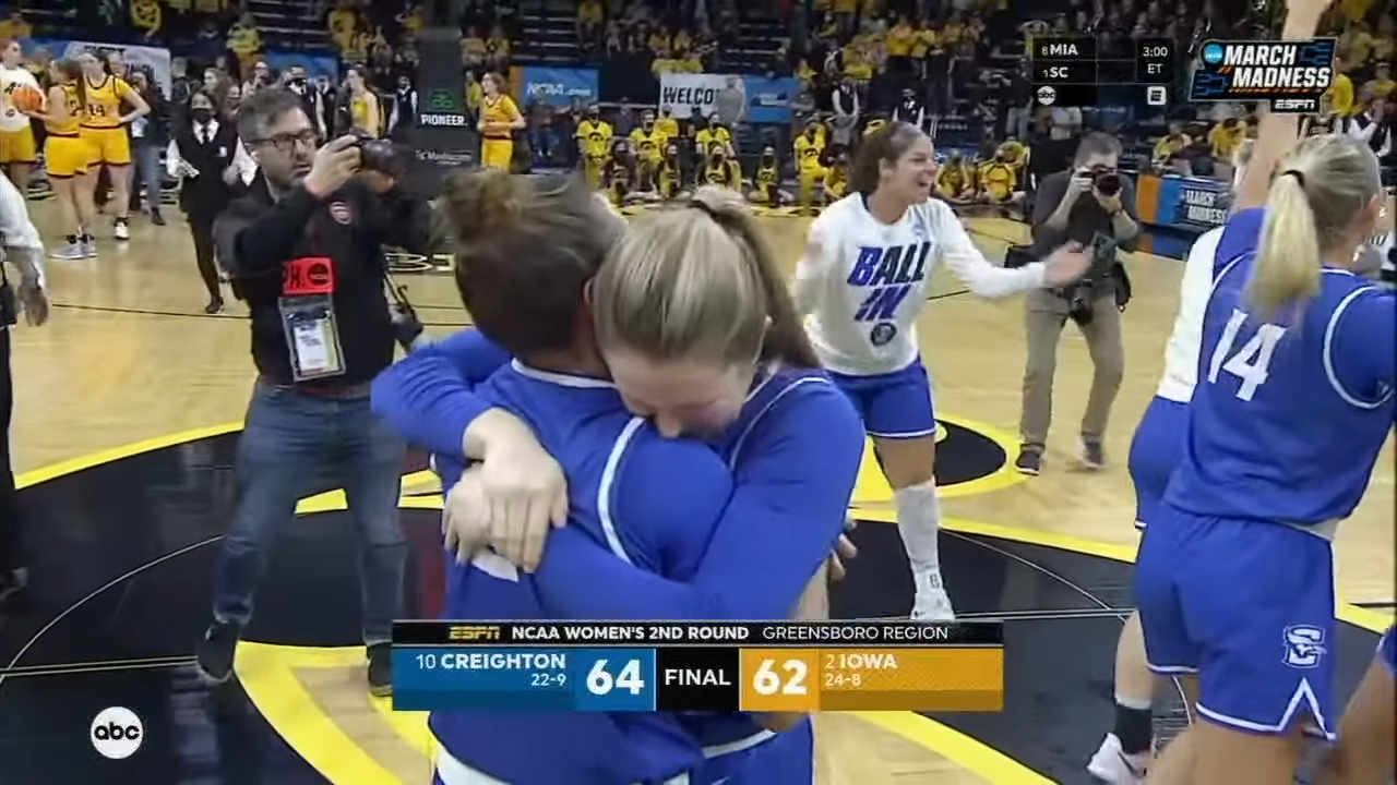 Members of the Creighton Bluejays women's basketball team celebrating after upsetting Iowa to make it to the Sweet 16.