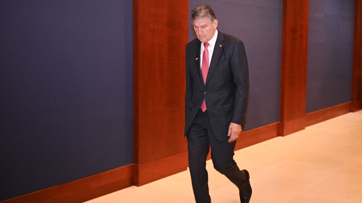 Senator Joe Manchin, D-WV, departs after attending Ukraine President Volodymyr Zelensky's video joint address to Congress in the Congressional Auditorium at the US Capitol in Washington, DC on March 16, 2022. (Photo by MANDEL NGAN / AFP) (Photo by MANDEL NGAN/AFP via Getty Images)