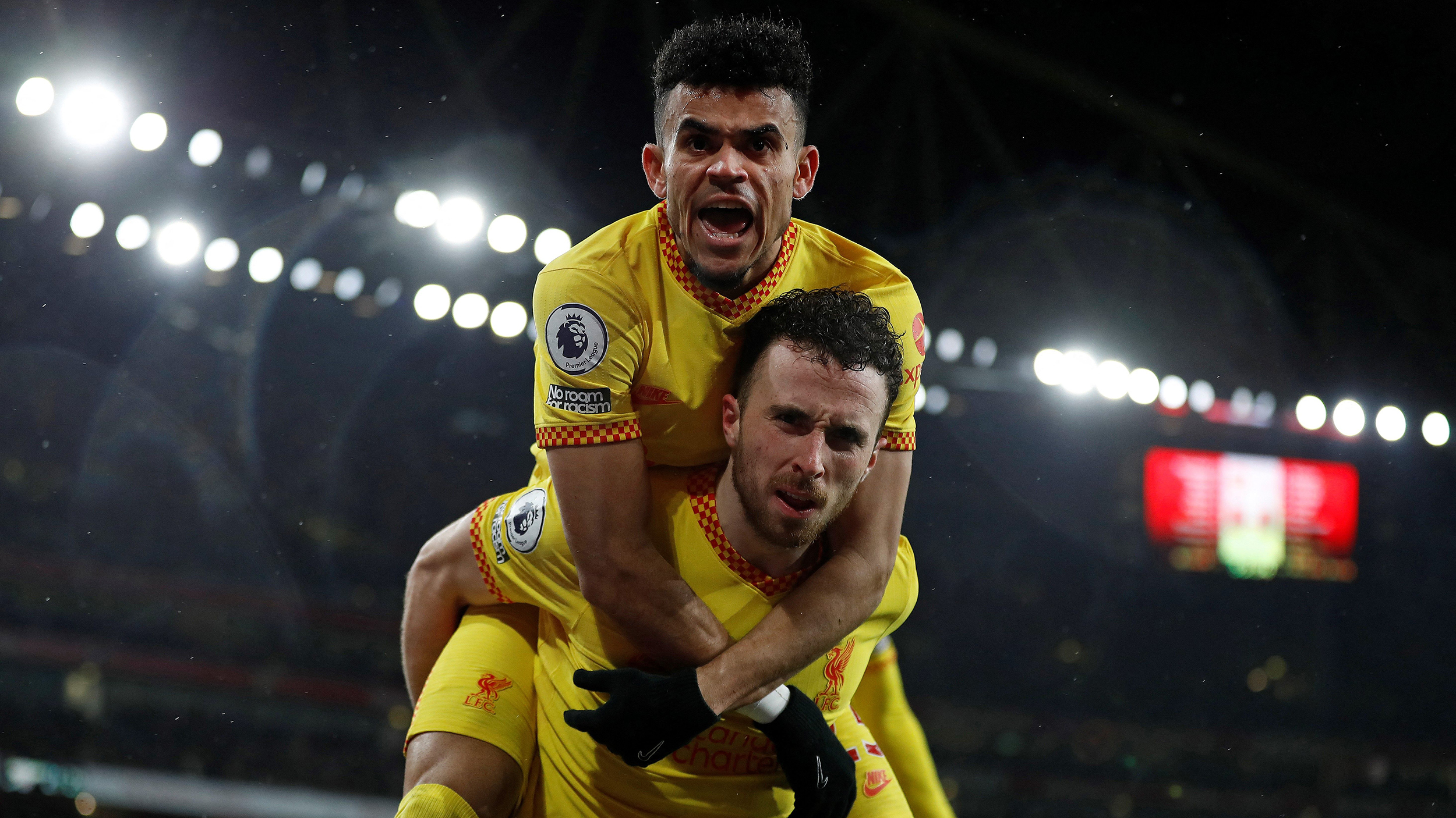 Liverpool's Portuguese striker Diogo Jota celebrates scoring the opening goal with Liverpool's Colombian midfielder Luis Diaz during the English Premier League football match between Arsenal and Liverpool at the Emirates Stadium in London on March 16, 2022.