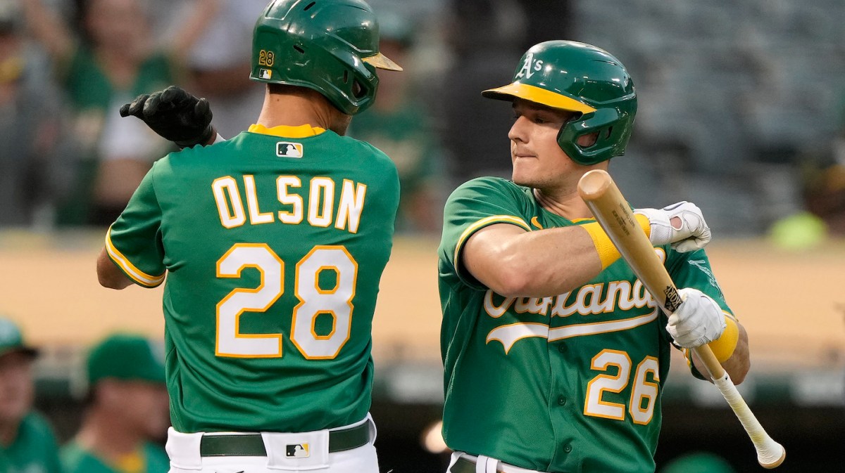 OAKLAND, CALIFORNIA - SEPTEMBER 21: Matt Olson #28 and Matt Chapman #26 of the Oakland Athletics celebrate after Olson hit a solo home run against the Seattle Mariners in the bottom of the first inning at RingCentral Coliseum on September 21, 2021 in Oakland, California. (Photo by Thearon W. Henderson/Getty Images)