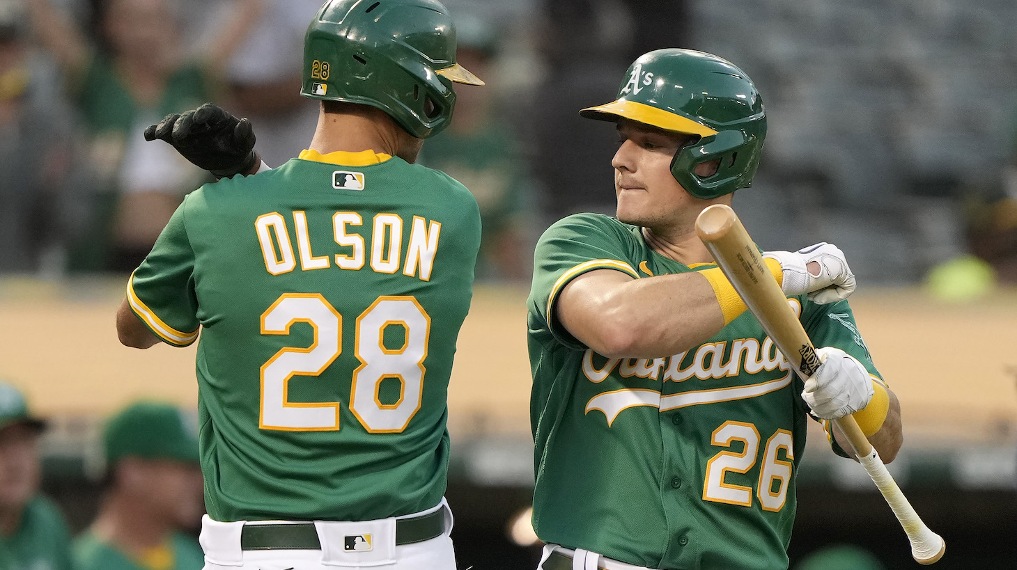 OAKLAND, CALIFORNIA - SEPTEMBER 21: Matt Olson #28 and Matt Chapman #26 of the Oakland Athletics celebrate after Olson hit a solo home run against the Seattle Mariners in the bottom of the first inning at RingCentral Coliseum on September 21, 2021 in Oakland, California. (Photo by Thearon W. Henderson/Getty Images)