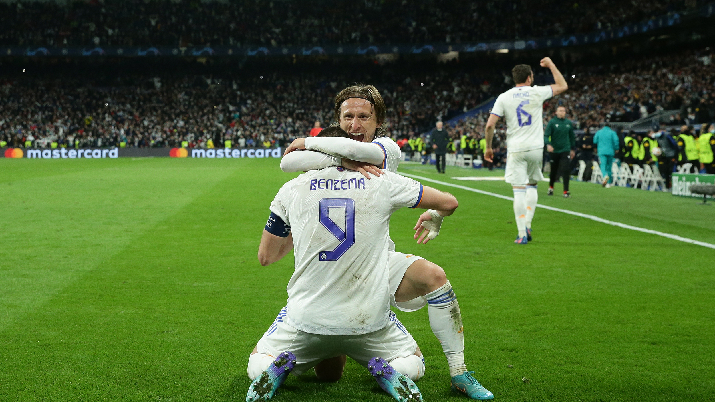 Karim Benzema (L) Real Madrid CF celebrates scoring their third goal with teammate Luka Modric (R) during the UEFA Champions League Round Of Sixteen Leg Two match between Real Madrid and Paris Saint-Germain at Estadio Santiago Bernabeu on March 09, 2022 in Madrid, Spain.