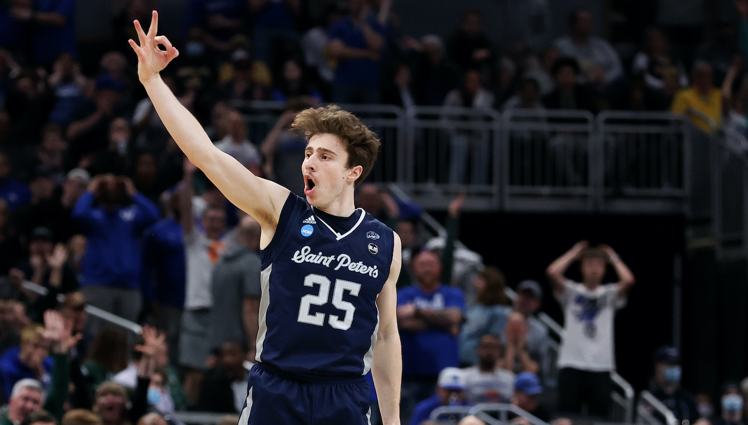 INDIANAPOLIS, INDIANA - MARCH 17: Doug Edert #25 of the Saint Peter's Peacocks celebrates after making a three-point basket against the during the second half in the first round game of the 2022 NCAA Men's Basketball Tournament at Gainbridge Fieldhouse on March 17, 2022 in Indianapolis, Indiana. (Photo by Dylan Buell/Getty Images)