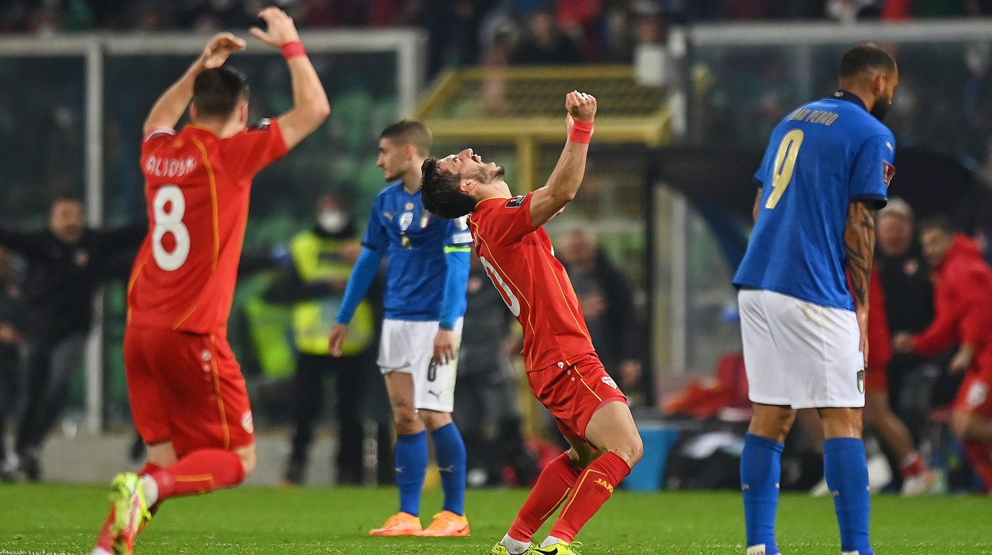 Stefan Spirovski of North Macedonia celebrates their side's victory as Joao Pedro Galvao of Italy looks dejected after the 2022 FIFA World Cup Qualifier knockout round play-off match between Italy and North Macedonia at Stadio Renzo Barbera on March 24, 2022 in Palermo, Italy.