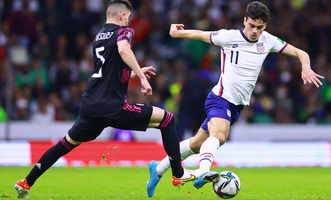 Giovanni Reyna of United States fights for the ball with Johan Vásquez of Mexico during a match between Mexico and United States as part of Concacaf 2022 FIFA World Cup Qualifiers at Azteca Stadium on March 24, 2022 in Mexico City, Mexico.
