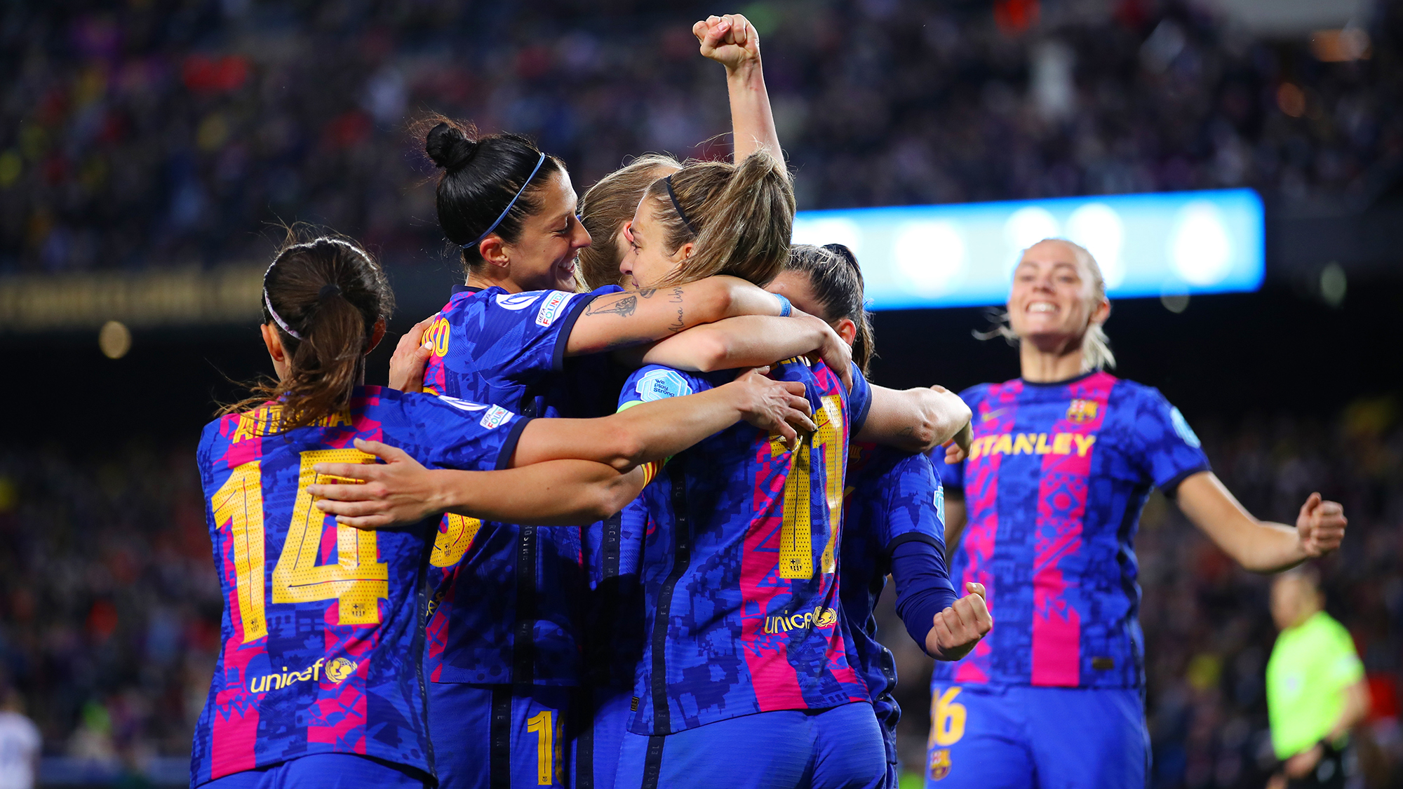 Alexia Putellas of FC Barcelona (obscured) celebrates with teammates after scoring their team's fourth goal during the UEFA Women's Champions League Quarter Final Second Leg match between FC Barcelona and Real Madrid at Camp Nou on March 30, 2022 in Barcelona, Spain.