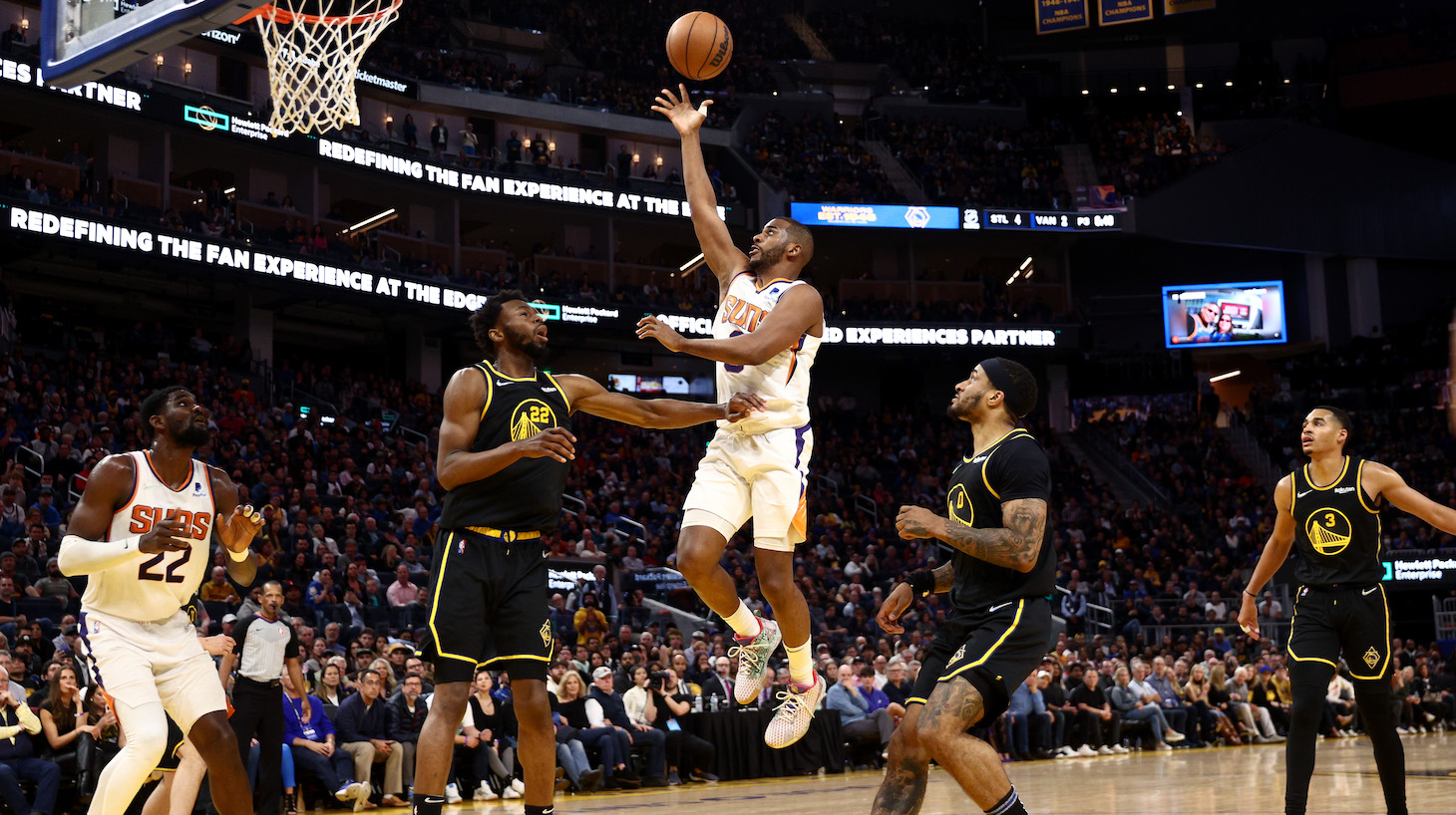 SAN FRANCISCO, CALIFORNIA - MARCH 30: Chris Paul #3 of the Phoenix Suns shoots over Andrew Wiggins #22 of the Golden State Warriors in the second half at Chase Center on March 30, 2022 in San Francisco, California. NOTE TO USER: User expressly acknowledges and agrees that, by downloading and/or using this photograph, User is consenting to the terms and conditions of the Getty Images License Agreement. (Photo by Ezra Shaw/Getty Images)