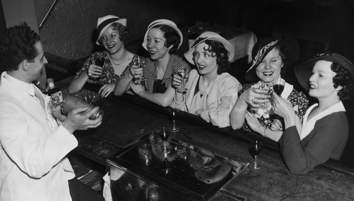 A group of young women in New York take advantage of a change in the licensing laws, permitting customers to drink while standing at the bar, 21st May 1934. (Photo by FPG/Hulton Archive/Getty Images)