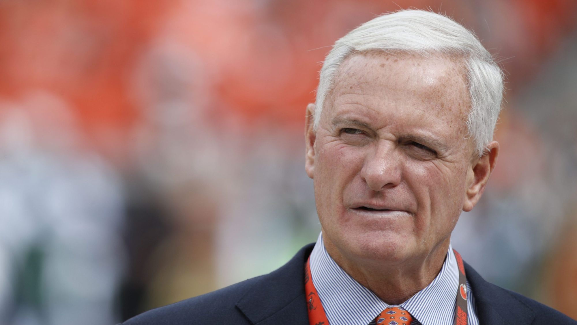 Cleveland Browns owner Jimmy Haslam is seen before the game against the New York Jets at FirstEnergy Stadium on October 8, 2017 in Cleveland, Ohio. He is wearing a suit, a Browns laniard, and has a confused look on his face.