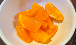 An orange, cut into slices