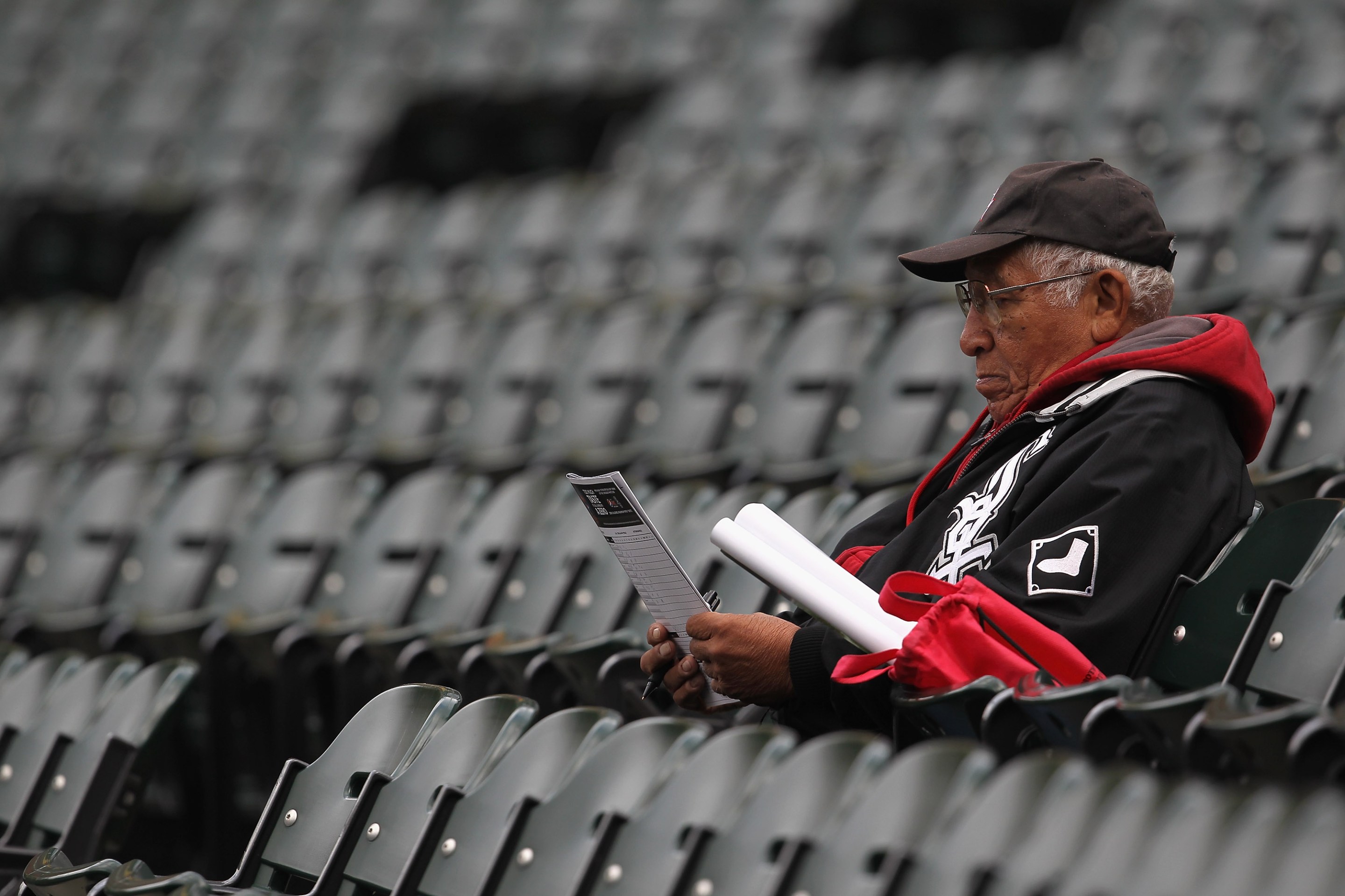 CHICAGO, IL - SEPTEMBER 28: A fan of the Chicago White Sox looks over his scorecard in the outfield during the last game of the season against the Toronto Blue Jays at U.S. Cellular Field on September 28, 2011 in Chicago, Illinois. The Blue Jays defeated the White Sox 3-2.