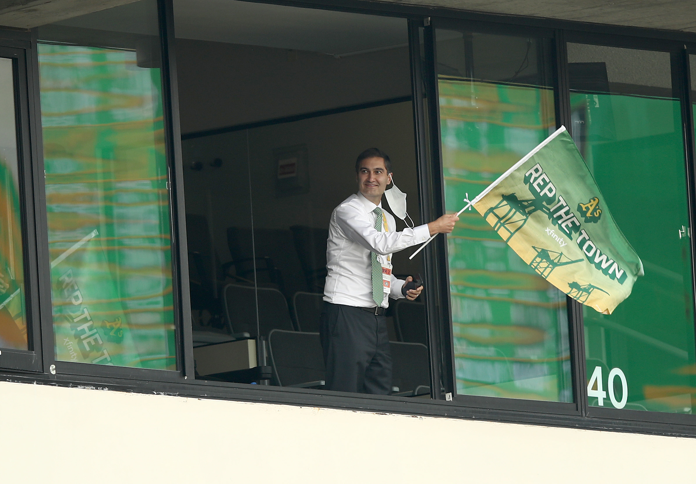 OAKLAND, CALIFORNIA - OCTOBER 01: Oakland Athletics team president Dave Kaval waves a flag after they tied their game against the Chicago White Sox in the fourth inning of Game Three of the American League wild card series at RingCentral Coliseum on October 01, 2020 in Oakland, California. (Photo by Ezra Shaw/Getty Images)