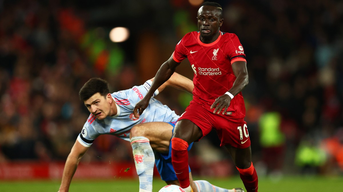 Harry Maguire of Manchester United looks on as Sadio Mane of Liverpool runs with the ball during the Premier League match between Liverpool and Manchester United at Anfield on April 19, 2022 in Liverpool, England.